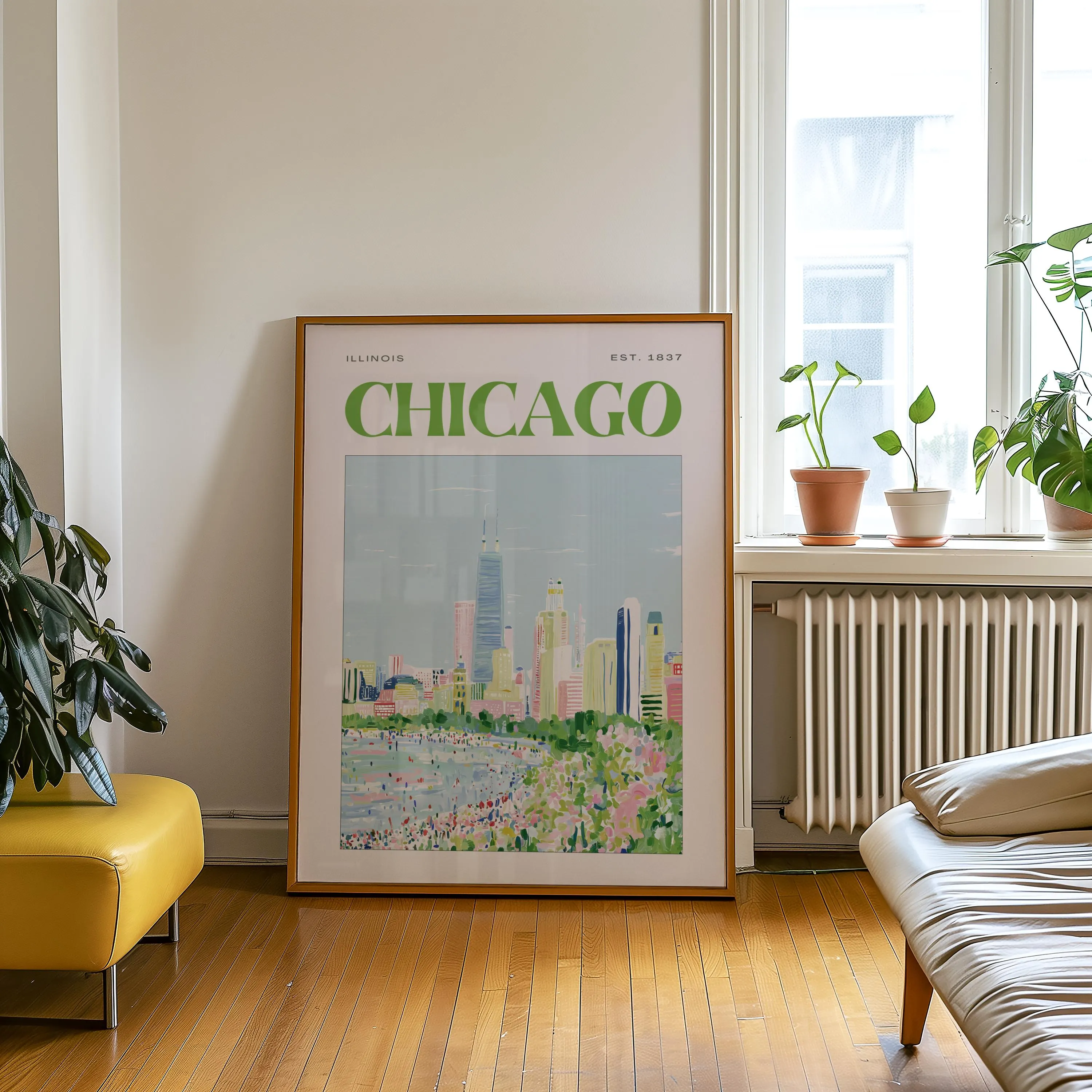 A framed wall art print featuring a stylized illustration of the Chicago skyline. The text reads "ILLINOIS" and "EST. 1837" above the large green "CHICAGO" lettering. The artwork depicts a city beach with colorful buildings.