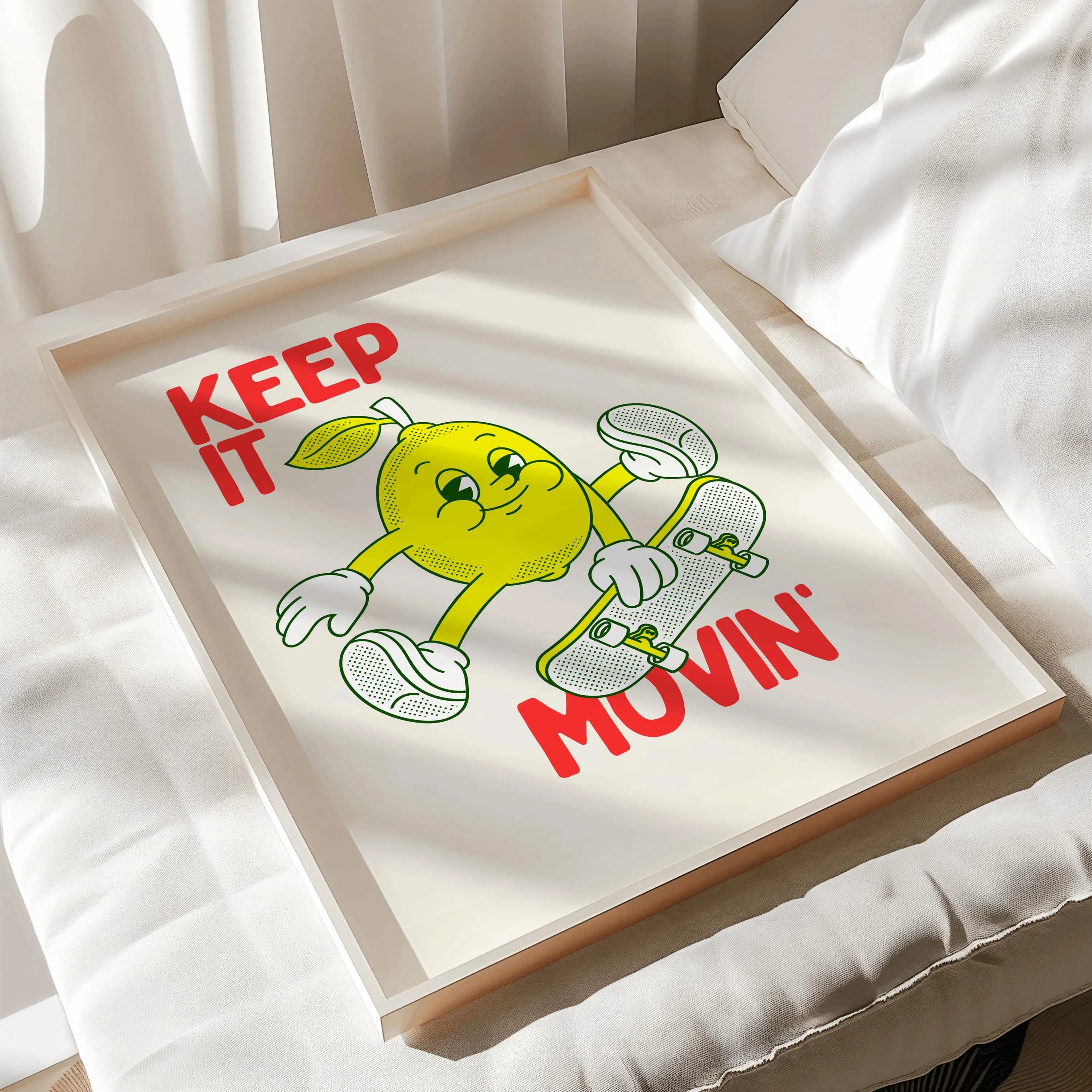 A framed print featuring a cartoon lemon character skateboarding. The lemon is yellow with white gloves and shoes, holding a skateboard. The words "KEEP IT MOVIN'" are printed in red.