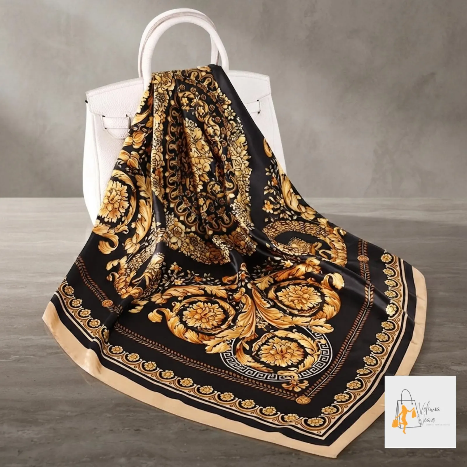 Printed satin scarf tied around a ponytail for a chic everyday look.