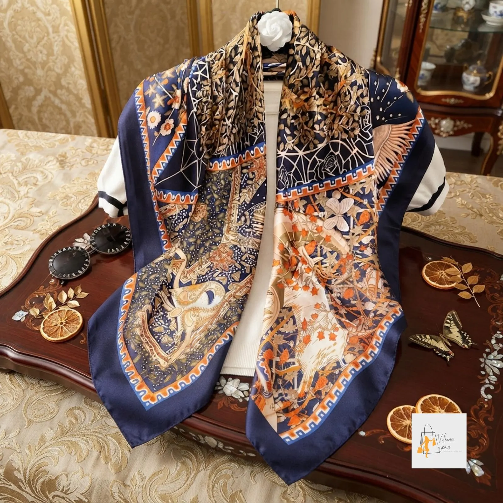 Elegant square scarf worn over the shoulders as a lightweight wrap.