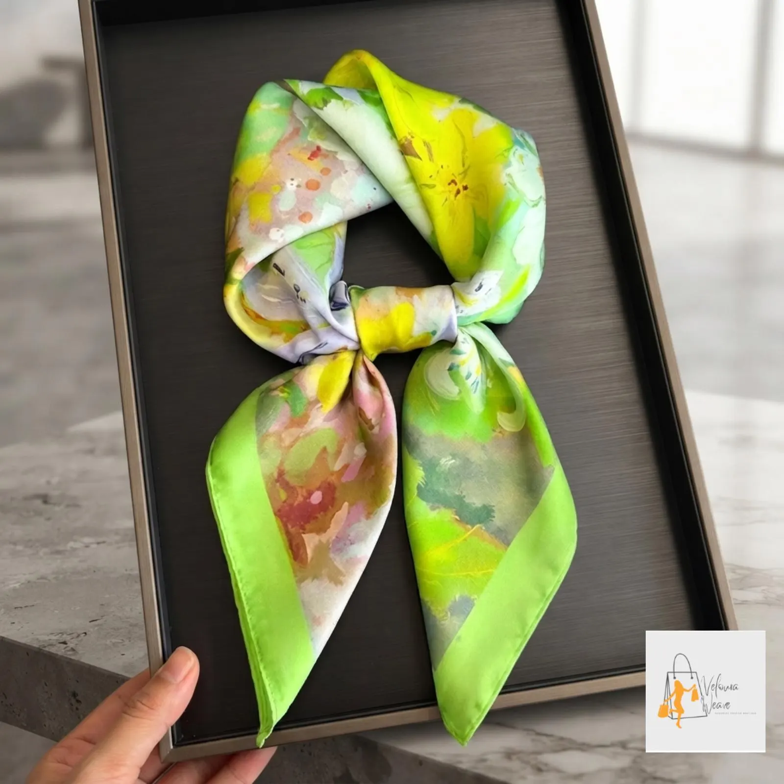 Floral printed square scarf styled around a woman's neck with a casual outfit.