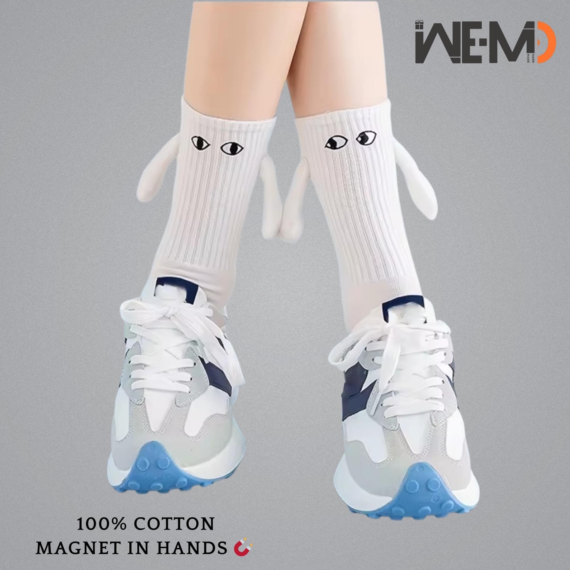 White magnetic holding hands socks made of cotton, shown paired with sneakers, cute couple accessory with magnets inside hands.