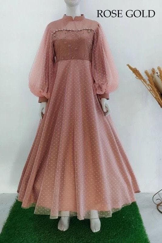 Long-sleeve velvet and dotted tulle modest wedding dress with beaded details displayed on a model