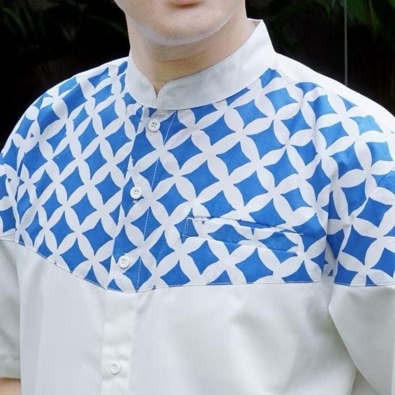 “Men’s white shirt with blue geometric chest print, made from premium anti-wrinkle cotton blend”