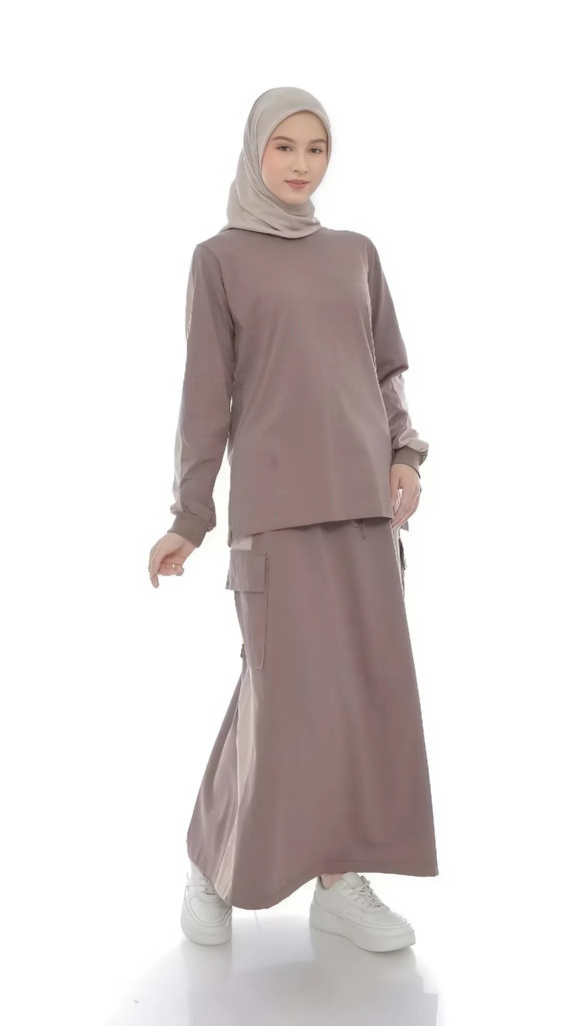 Two-piece modest cotton outfit with long-sleeve top and maxi skirt in taupe, worn by a woman standing against a white background.