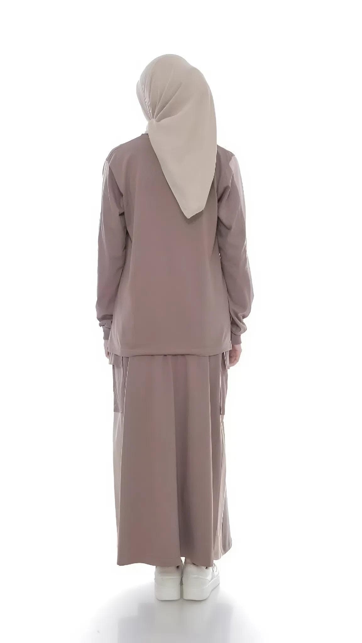 Two-piece modest cotton outfit with long-sleeve top and maxi skirt in taupe, worn by a woman standing against a white background.