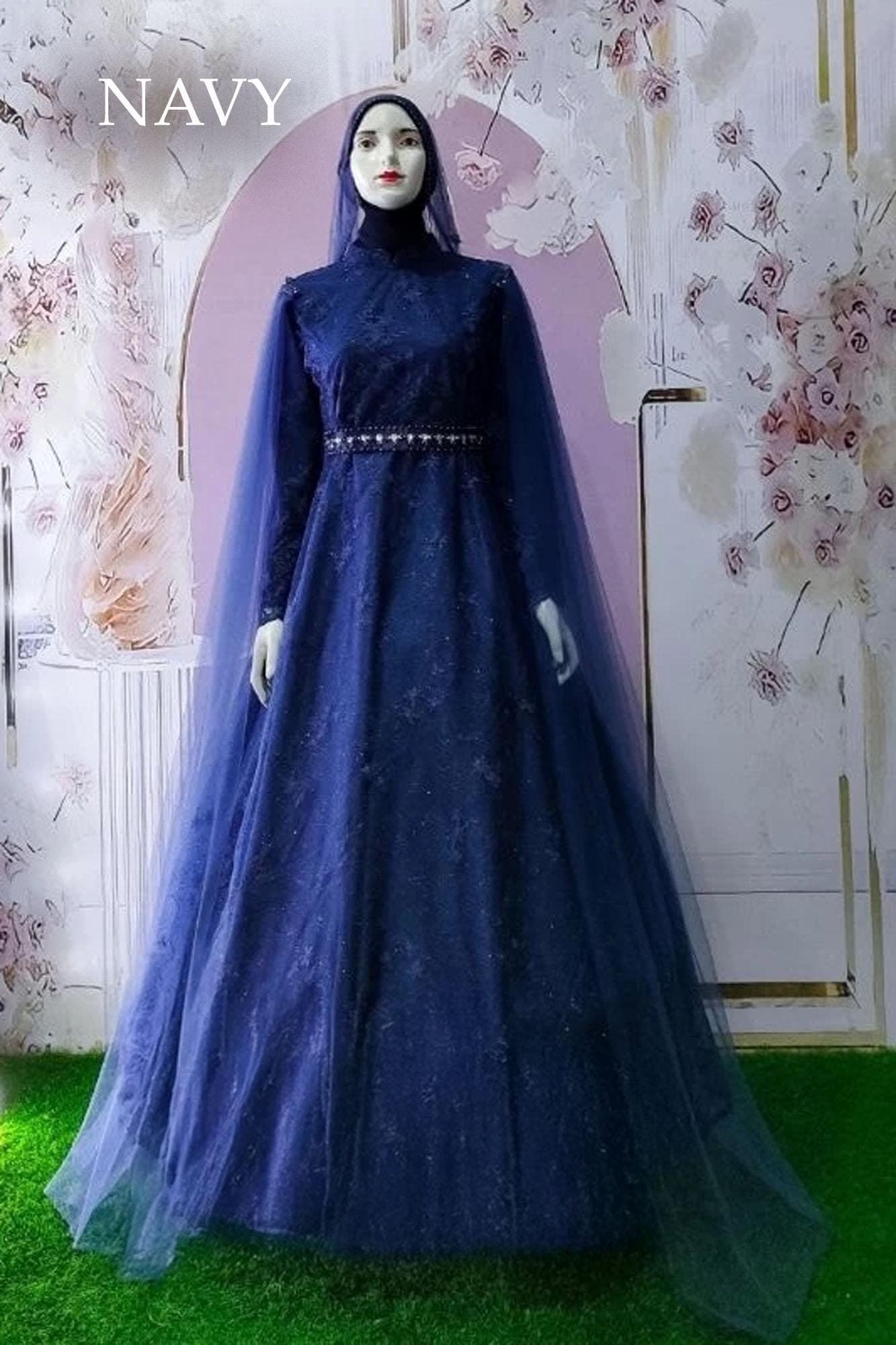 Embroidered tulle abaya gown with satin base and matching veil displayed on a mannequin, showing its full-length flowing silhouette.