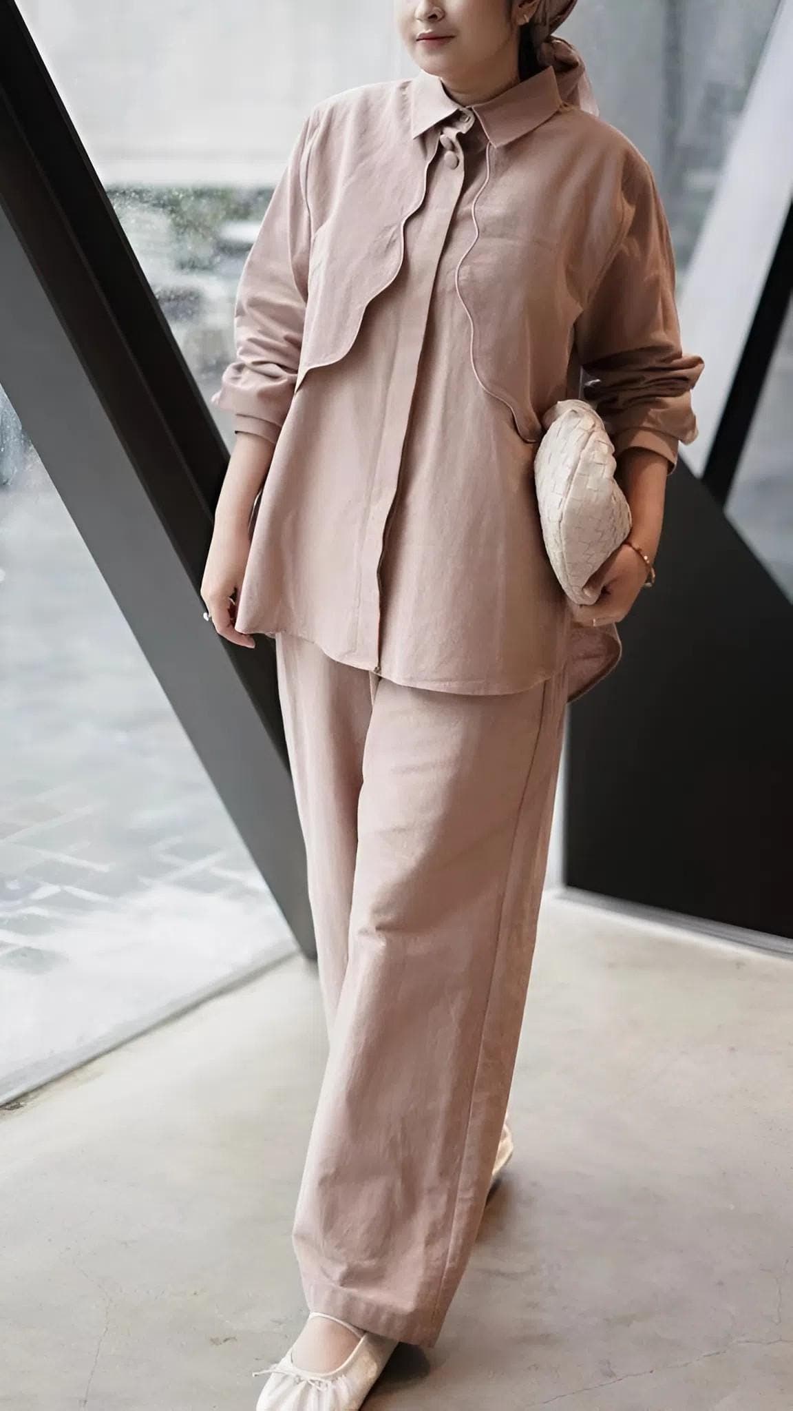 A premium linen two-piece outfit featuring a long-sleeve shirt and wide-leg pants in neutral earthy tones, styled for modest fashion.