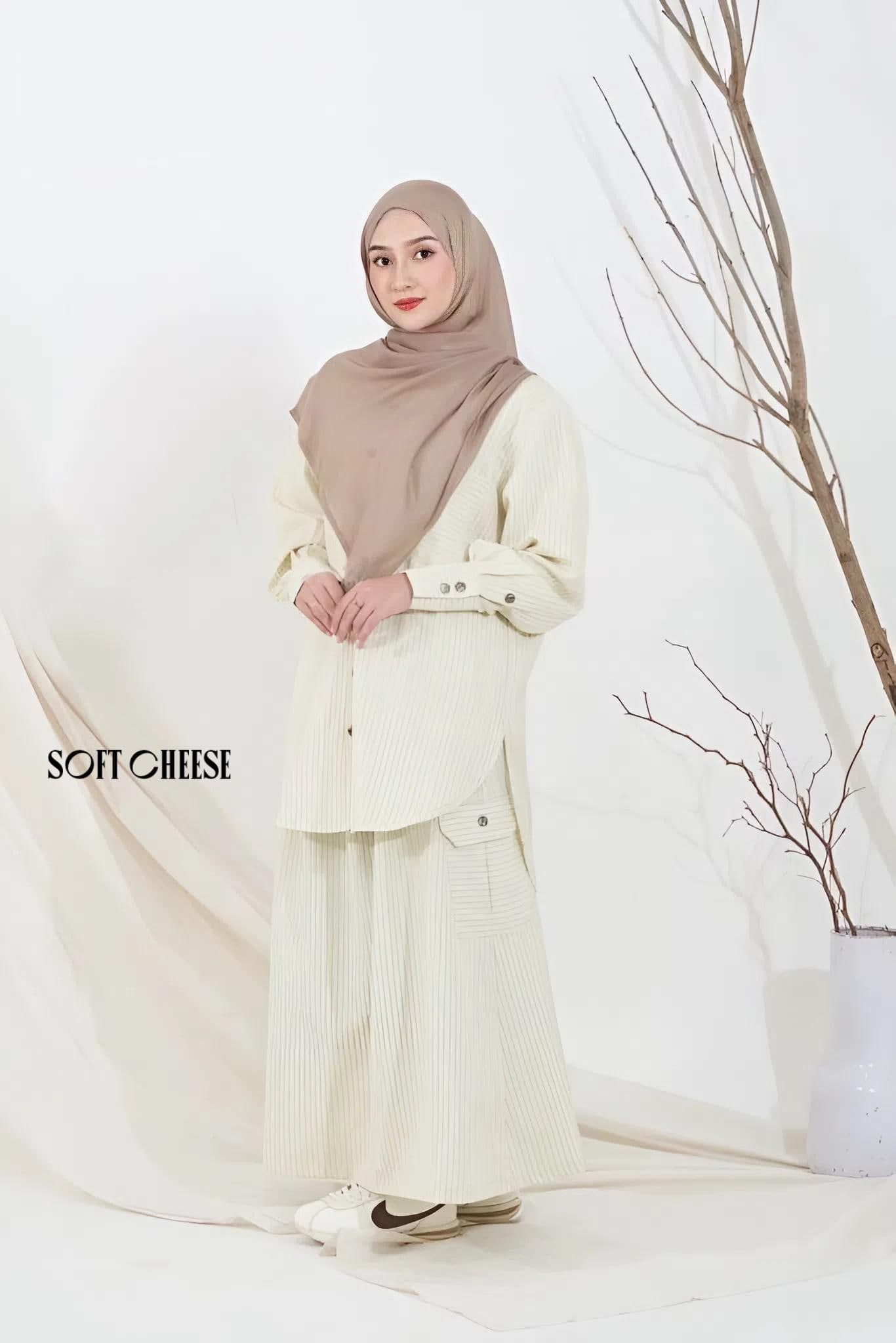 Two women wearing a striped modest two-piece set in cotton semiwool, featuring a long-sleeve top and matching skirt.