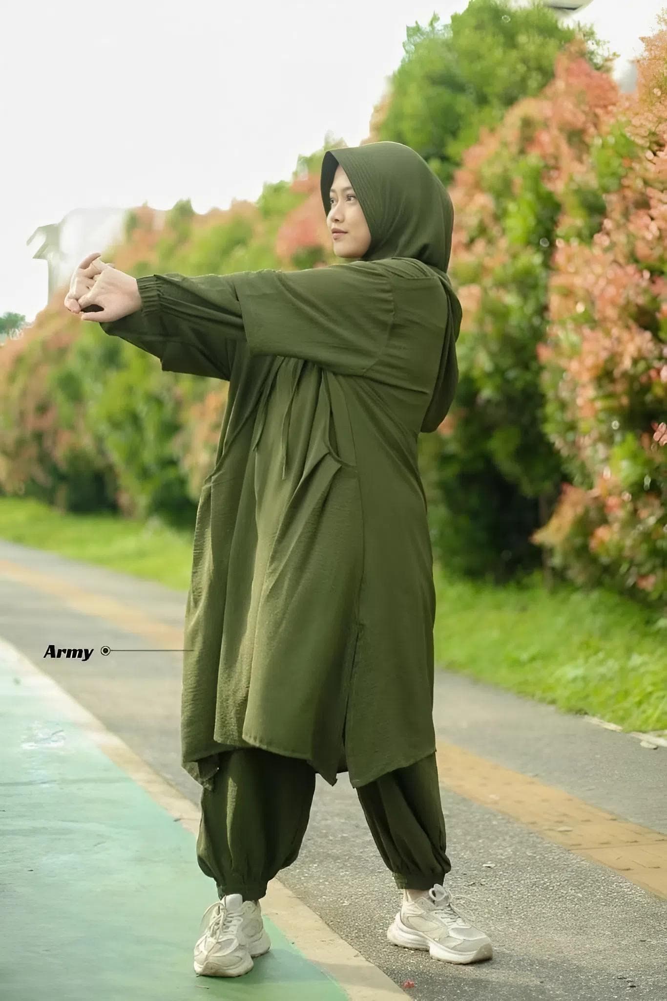 Muslim women modest sport set in apple green made from breathable Airflow crinkle fabric, featuring hooded long top and loose jogger pants, hijab-friendly activewear.