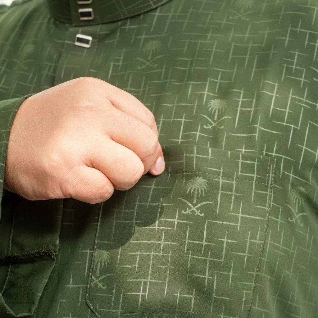 Plus size man wearing a dark gray premium embossed thobe with a stand collar and snap buttons