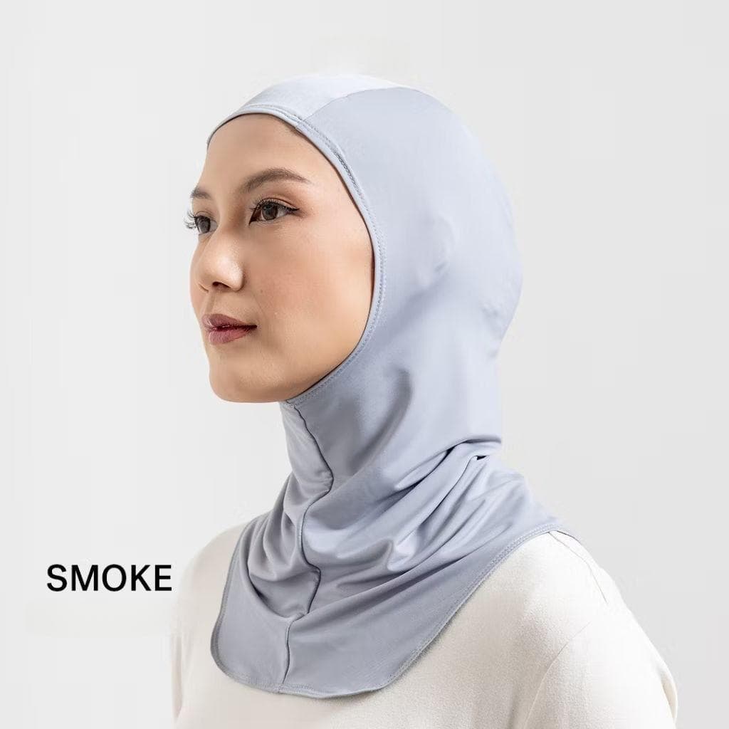 Woman wearing black nylon pull-on sports hijab with quick-dry material and snug athletic fit.