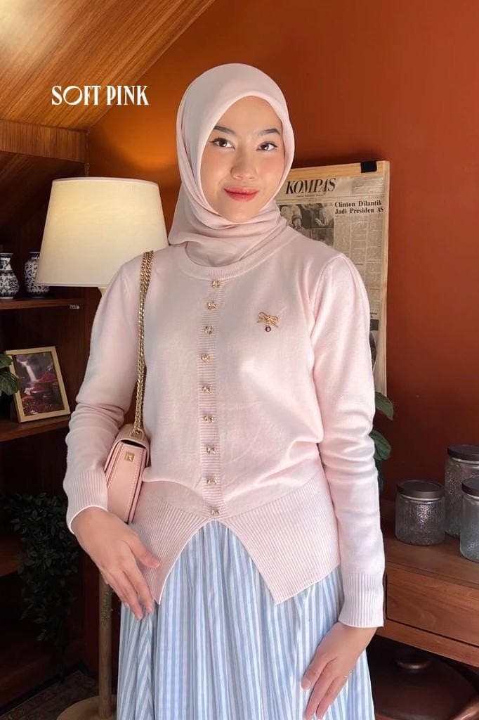 Premium knit button cardigan worn by a woman, featuring a modest fit and minimalist design in soft neutral colors