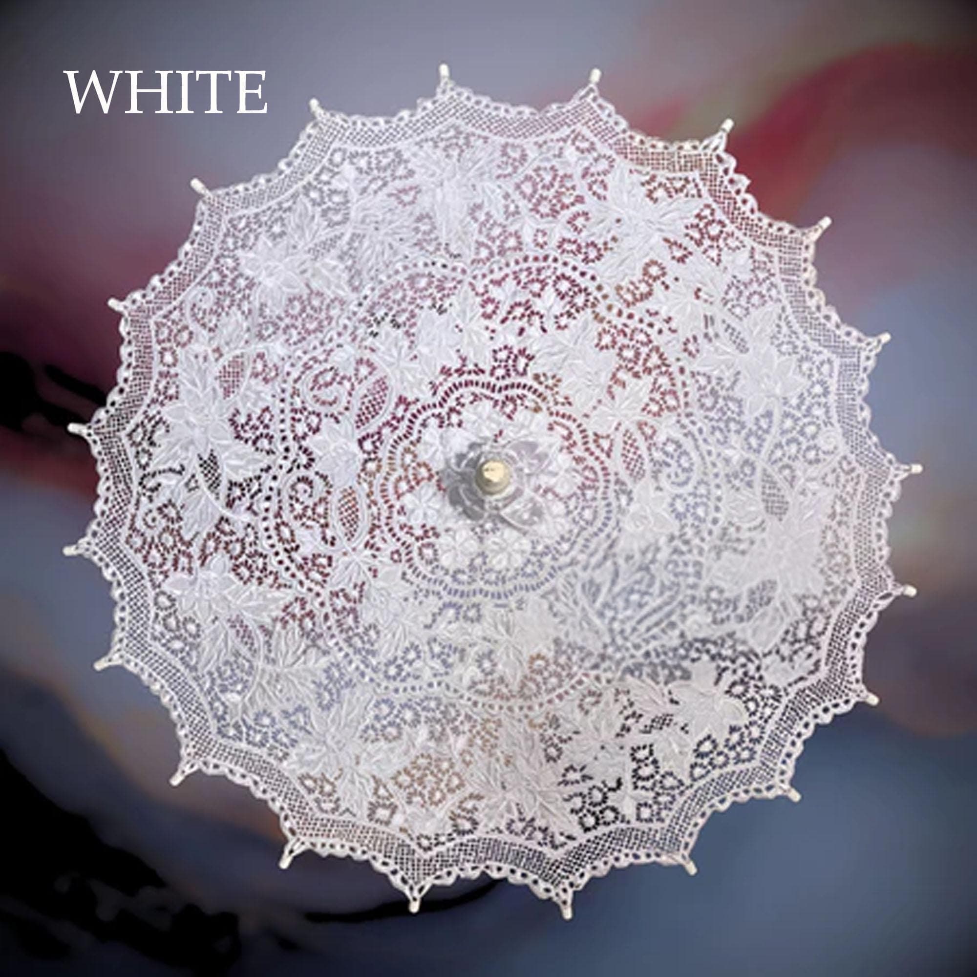 White embroidered lace parasol displayed outdoors with a wooden handle and floral pattern.