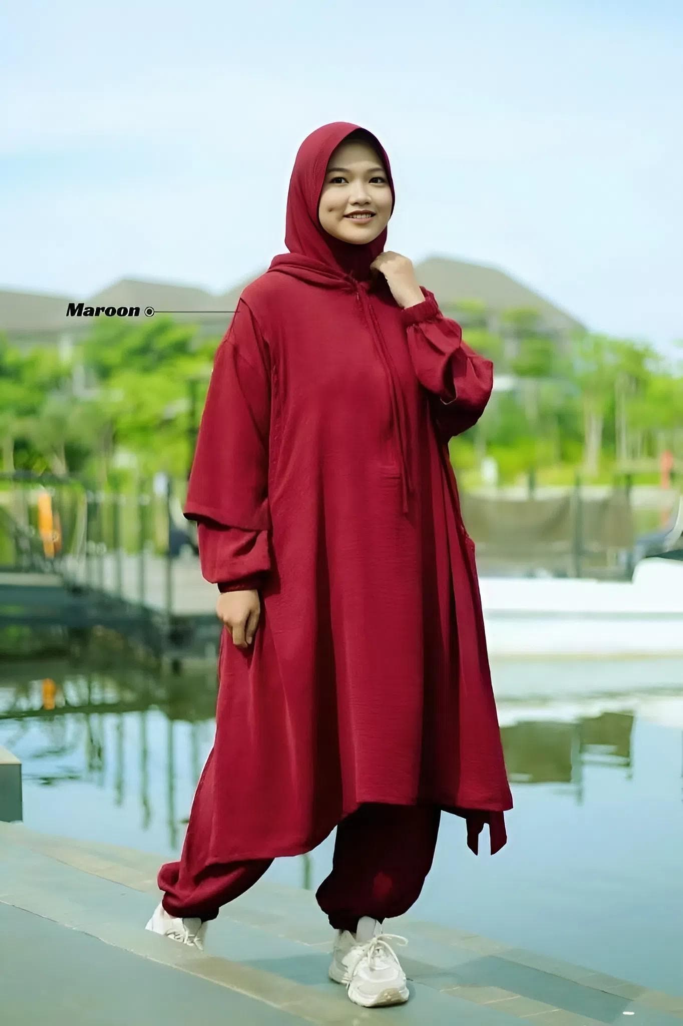 Muslim women modest sport set in apple green made from breathable Airflow crinkle fabric, featuring hooded long top and loose jogger pants, hijab-friendly activewear.