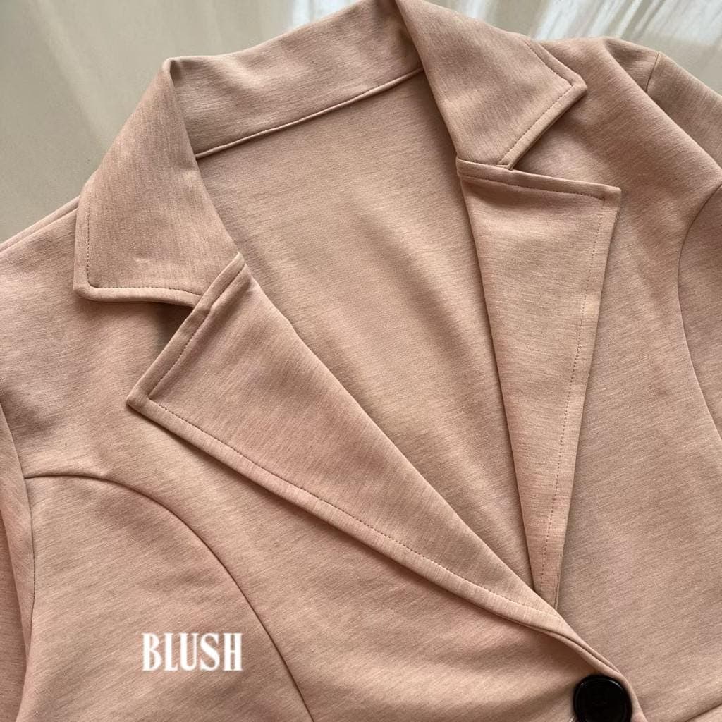 Soft cotton-blend long coat in pink peach color with lapel collar and button closure, made from stretch interlock fabric