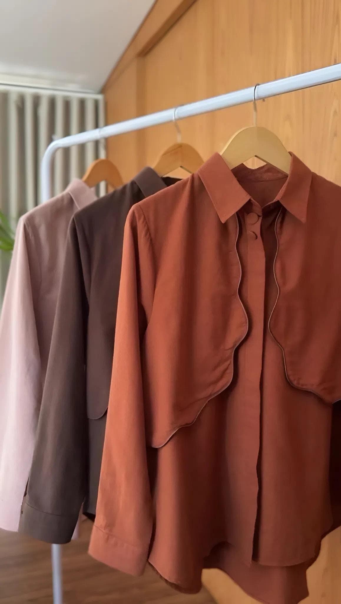 A premium linen two-piece outfit featuring a long-sleeve shirt and wide-leg pants in neutral earthy tones, styled for modest fashion.