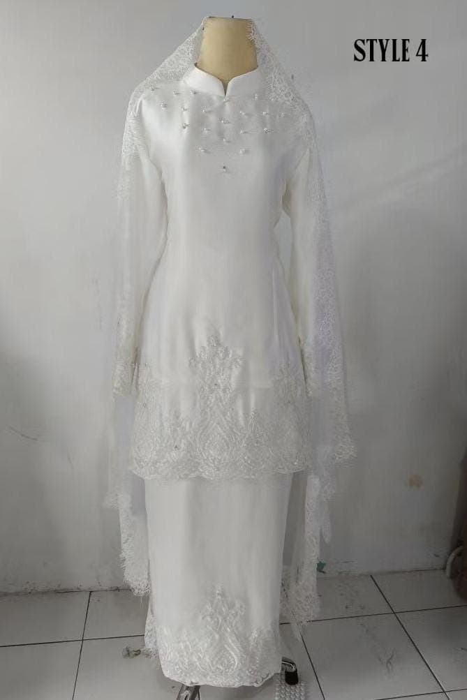 White long-sleeve formal dress with lace and bead embellishments displayed on a mannequin, paired with a matching skirt and veil.