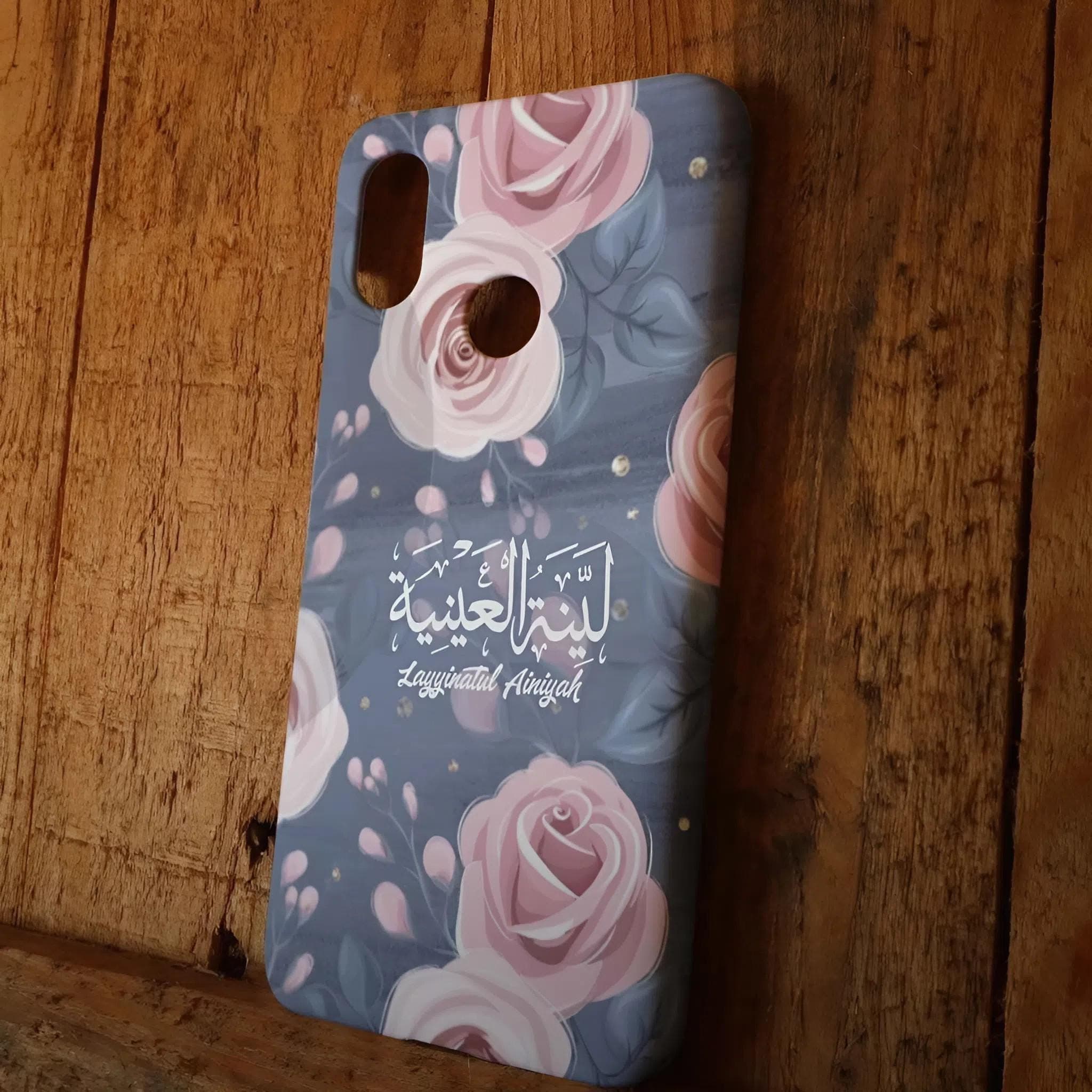 Personalized phone cases featuring detailed Arabic calligraphy, floral patterns, and historical architectural motifs in various finishes like matte black and clear.