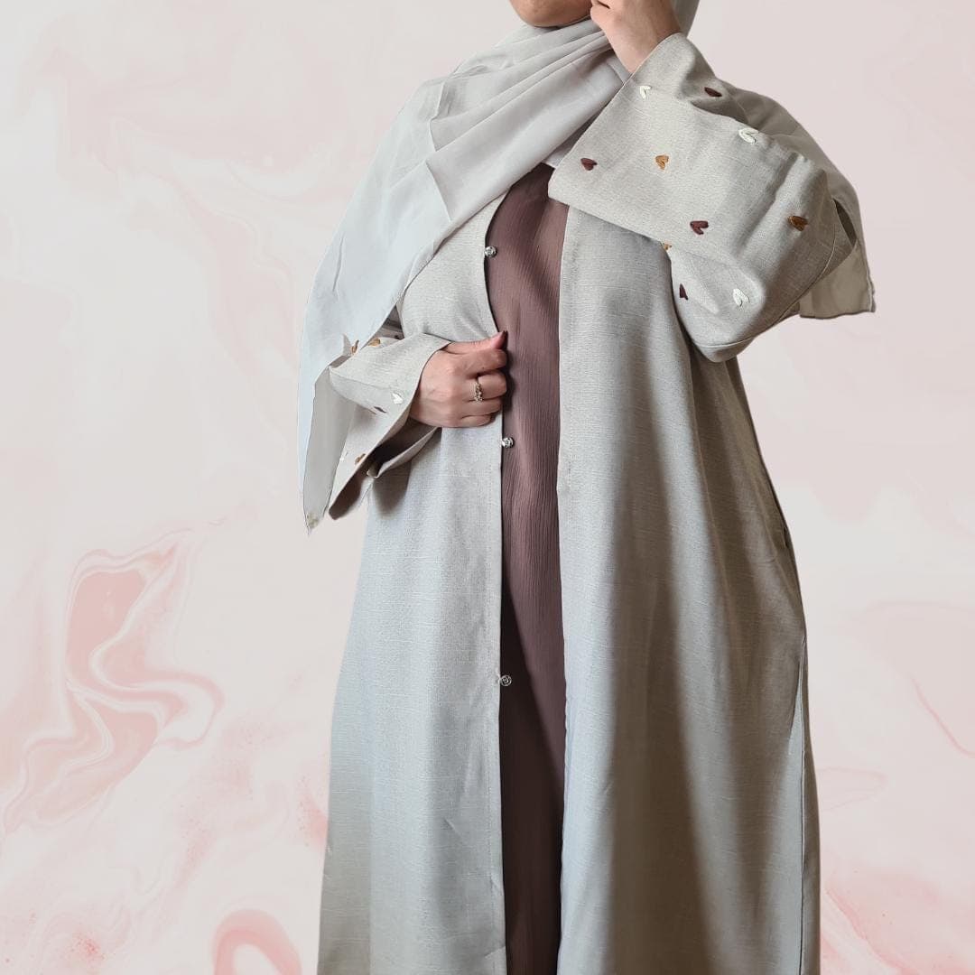 Elegant beige-grey abaya with embroidered heart designs on the sleeves, including hijab and practical pockets – ideal for everyday wear - image 3