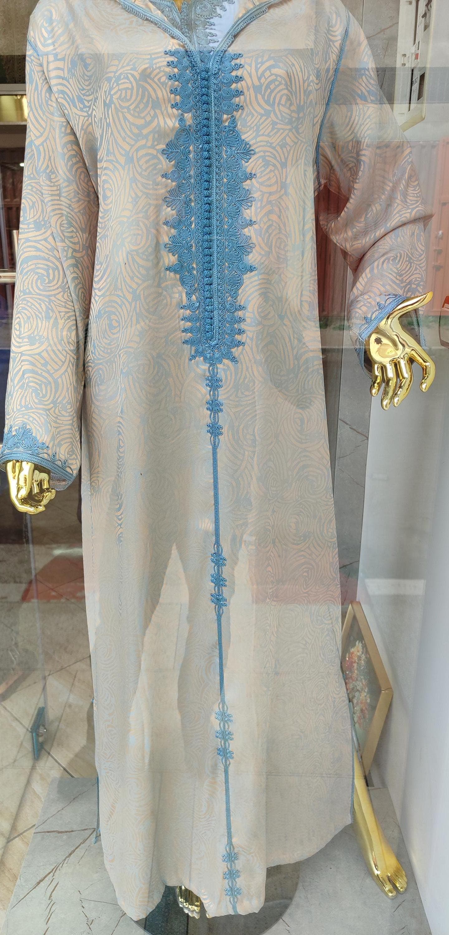 The wide sleeves of this traditional dress feature matching embroidery around the cuffs, with delicate patterns that mirror the front design. When touching the sleeves of this jellaba handmade garment, you'll notice the generous cut that allows for comfortable movement. The ethnic clothing tradition of Morocco emphasizes both practicality and beauty, creating a statement piece that's functional for everyday wear.