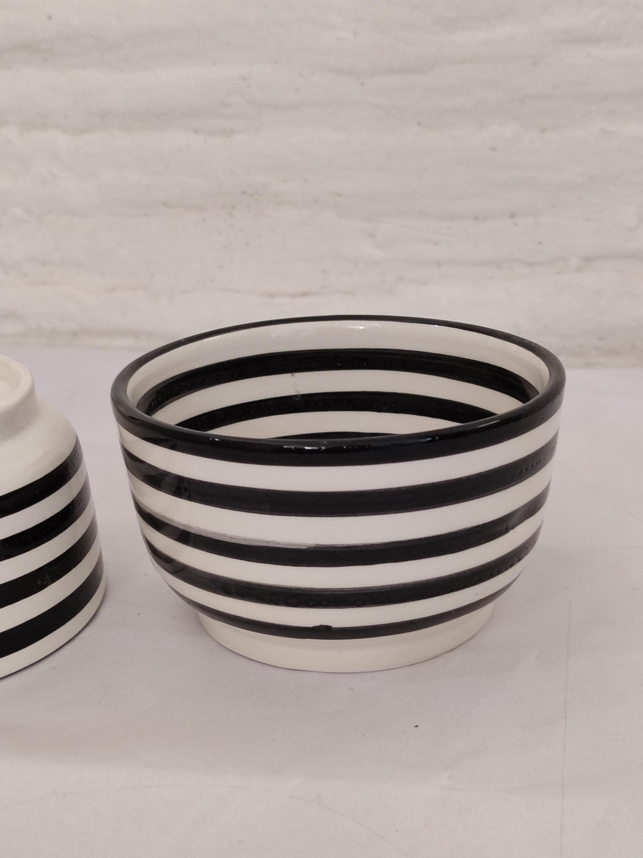 Add a rustic yet modern touch to your kitchen with these handmade Moroccan bowls. The striking black and white stripes create visual interest, while the ceramic construction ensures practicality and longevity. These decorative bowls are ideal for serving appetizers, desserts, or as stylish prep bowls during cooking. Their boho minimalist aesthetic makes them versatile for both casual and formal settings. Whether used as centerpiece bowls or everyday dishware,