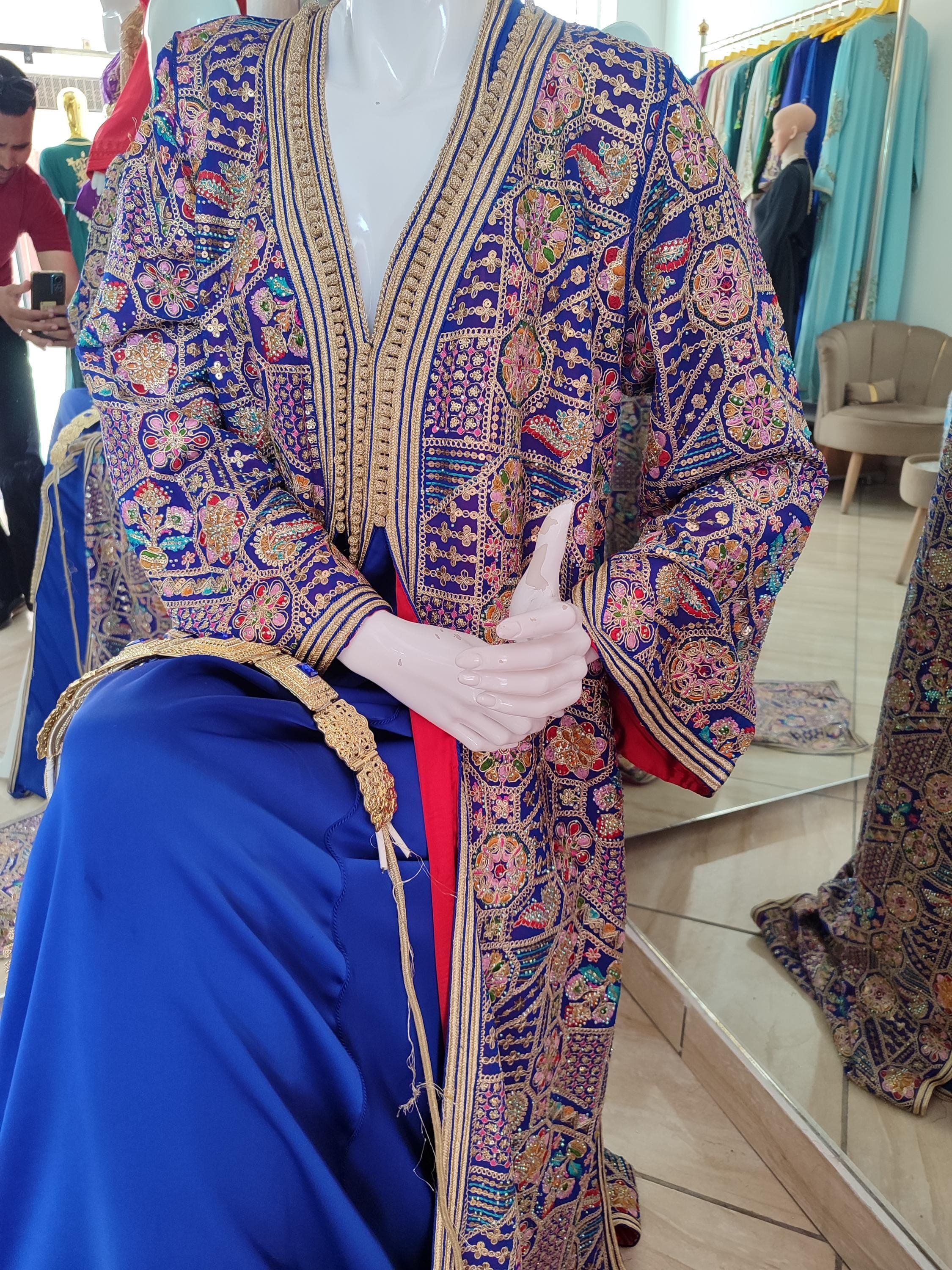 Experience regal elegance in our premium takchita dresses collection, designed for discerning brides. This bridal thobe combines rich fabrics with hand-sewn embellishments in gold and silver thread. The Arabic kuftan design features a flattering V-neckline and voluminous sleeves, perfect for Islamic dress women seeking modest yet glamorous attire.