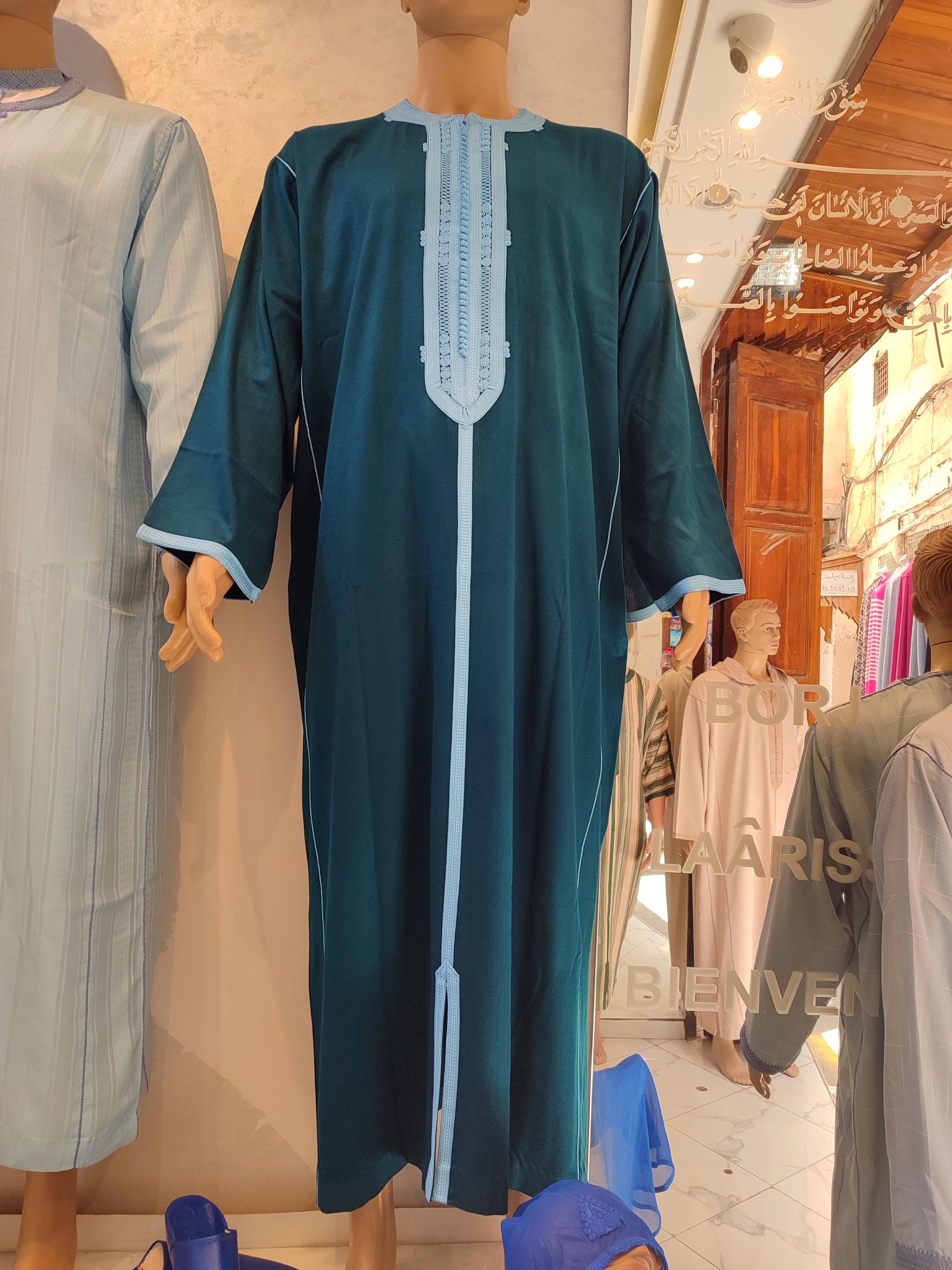 This Islamic men’s jalabiya blends heritage with elegance, crafted as a jubba for Muslim weddings, Eid gatherings, or everyday prayer wear. The overcoat style is perfect over a traditional thobe or long kurta, offering a modest and refined look. A fusion of Turkish jubba and Berber djellaba influence in one timeless garment.