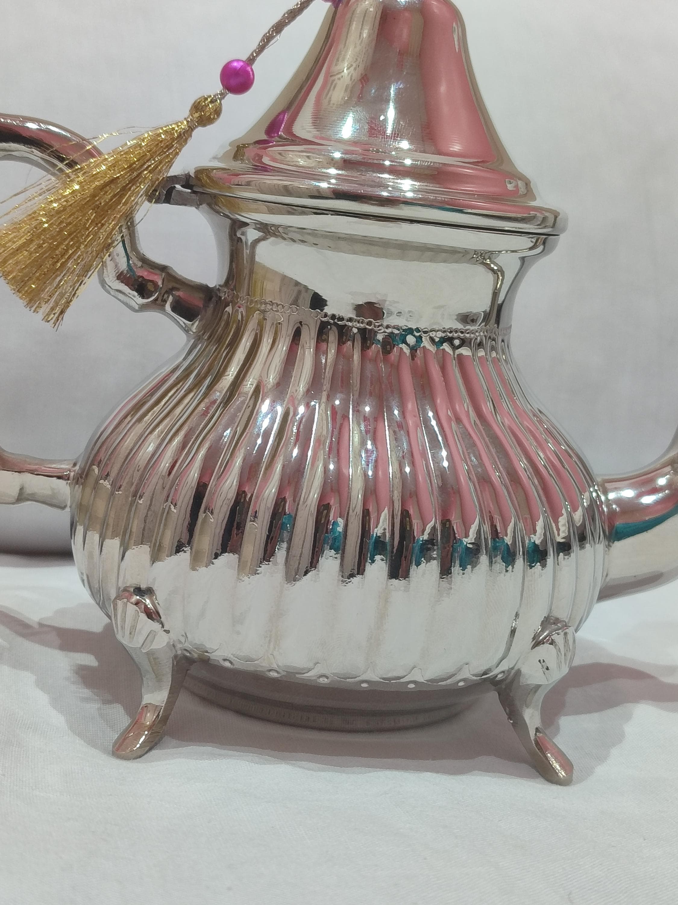 Discover this stunning artisanal teapot that captures the spirit of teapot Morocco. Crafted from high-quality silver brass, this traditional teapot features elaborate hand-engraved designs inspired by Moroccan architecture and patterns. The ergonomic handle and balanced spout make serving Moroccan mint tea a graceful experience. With its antique finish and timeless appeal, this Arabic teapot serves as both a practical tea vessel and an exquisite decorative object.