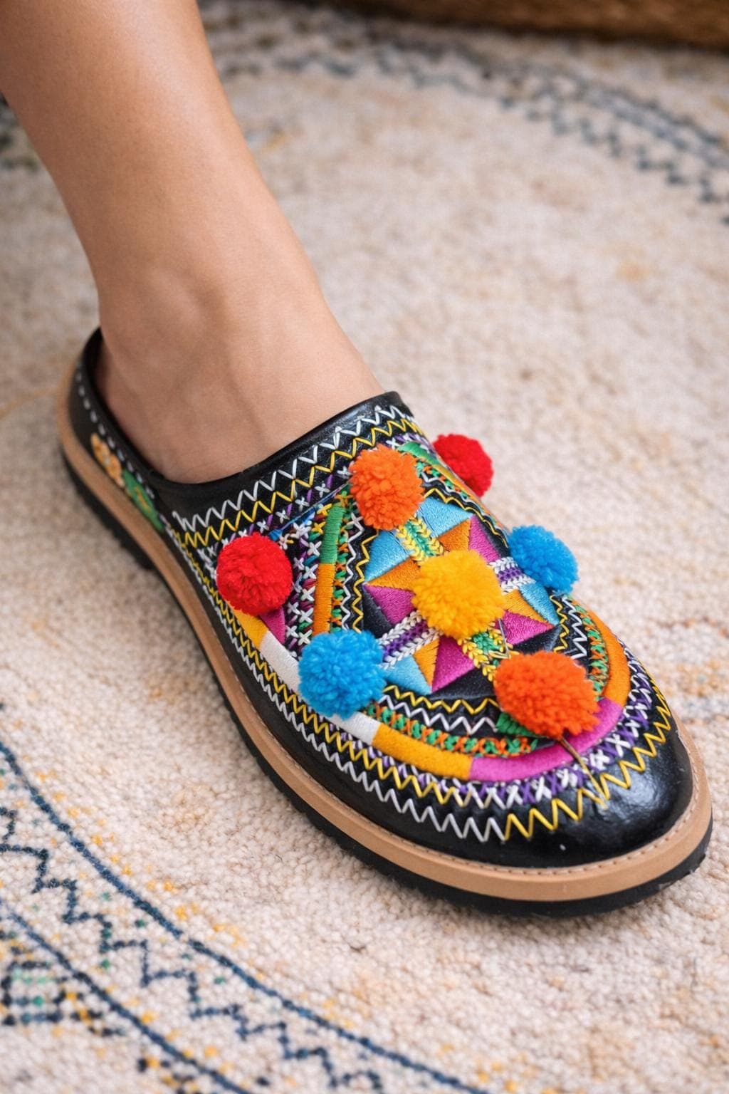Elevate your loungewear with these beautifully detailed handmade slippers. Featuring intricate embroidery on soft leather, these babouche slippers are more than just indoor slippers they're a statement of boho elegance. The pointed toe and slipper-back heel maintain the authentic Moroccan silhouette while the artisan stitching adds a unique, personal touch. A perfect gift for anyone who appreciates globally-inspired, feminine details.
