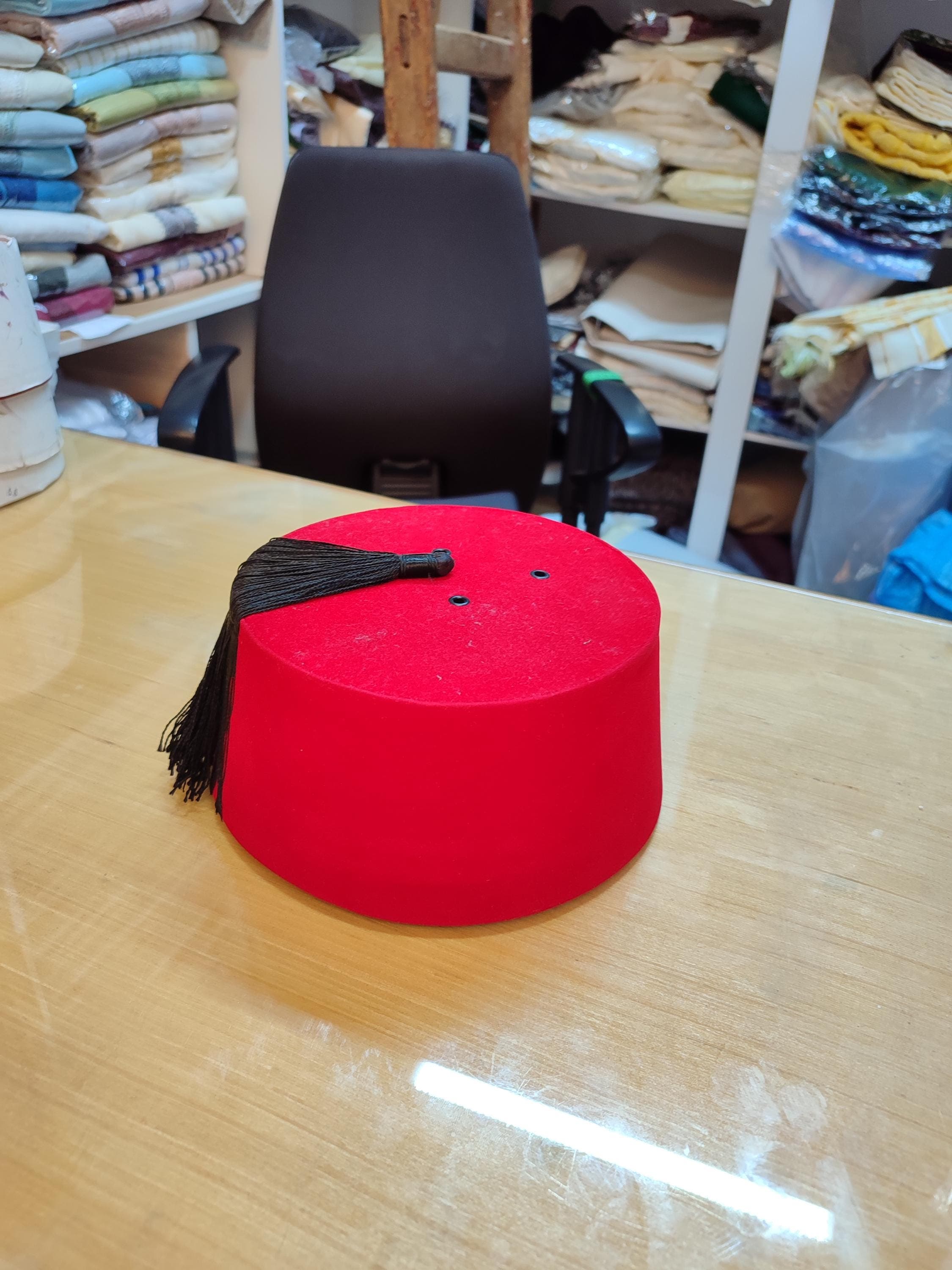 Step into history with this traditional Moorish hat, a beautiful Red Fez Tarbouche that echoes the styles of Andalus Moroccan heritage. This Handmade Fez Hat is constructed from sturdy felt and features the iconic cylindrical shape and dangling tassel. It's an essential ceremonial hat for cultural events and a fantastic, conversation-starting festival accessory. This Moroccan fez hat is more than just headwear; it's a piece of art, representing centuries of tradition and craftsmanship.