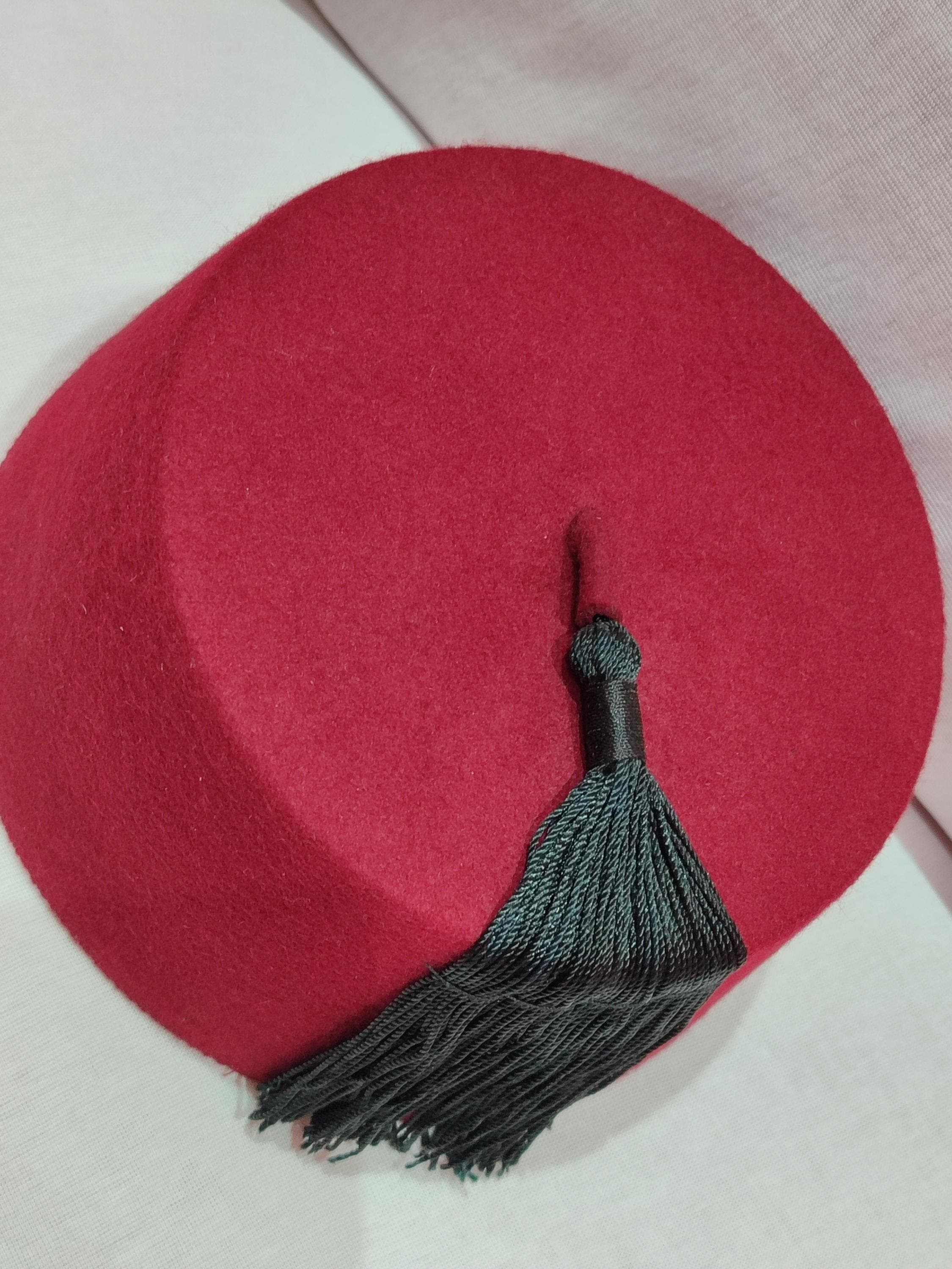 Step into the spotlight with our Luxury Moroccan Tarboush, a handtailored masterpiece crafted for elegance and comfort. This royal tarboush features a vibrant red hue, intricate hasira embroidery, and a graceful silk tassel. Whether worn as a doctor who hat or a men's prayer hat, this Fez hat exudes sophistication and cultural pride. Its lightweight design ensures all-day comfort, making it a perfect accessory for formal events or cultural celebrations.