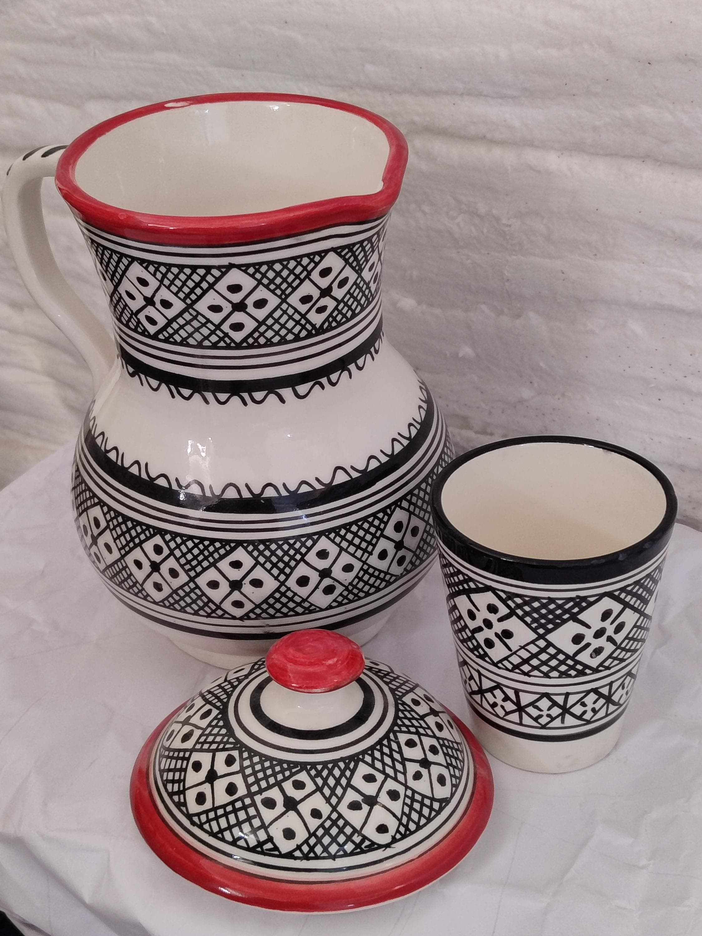 Discover the elegance of this turquoise carafe, a charming handmade carafe that merges Moroccan tradition with modern style. Use it as a bedside water carafe, a decorative pottery carafe, or a functional water pitcher. This ceramic carafe is part of a timeless carafe and cup pairing.
