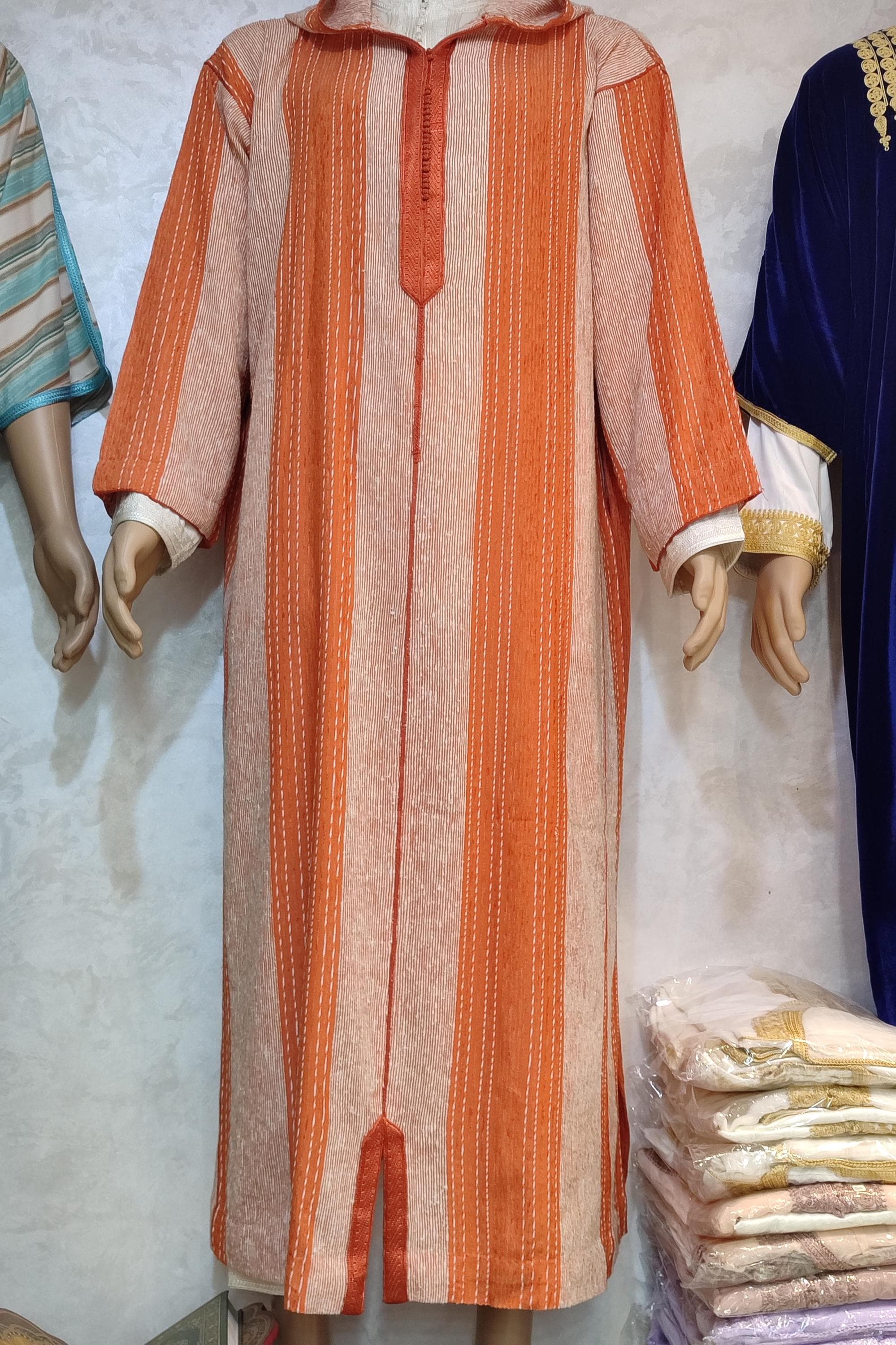 This authentic Moroccan wool djellaba is handcrafted by skilled Moroccan artisans using premium wool fabric. Perfect as a winter djellaba, this Berber djellaba features traditional embroidery and a cozy hooded design. The handmade djellaba offers both warmth and style, making it ideal for cold weather. Whether you're looking for Moroccan wool clothing or bohemian style fashion, this djellaba dress works for both men and women seeking authentic Moroccan fashion.
