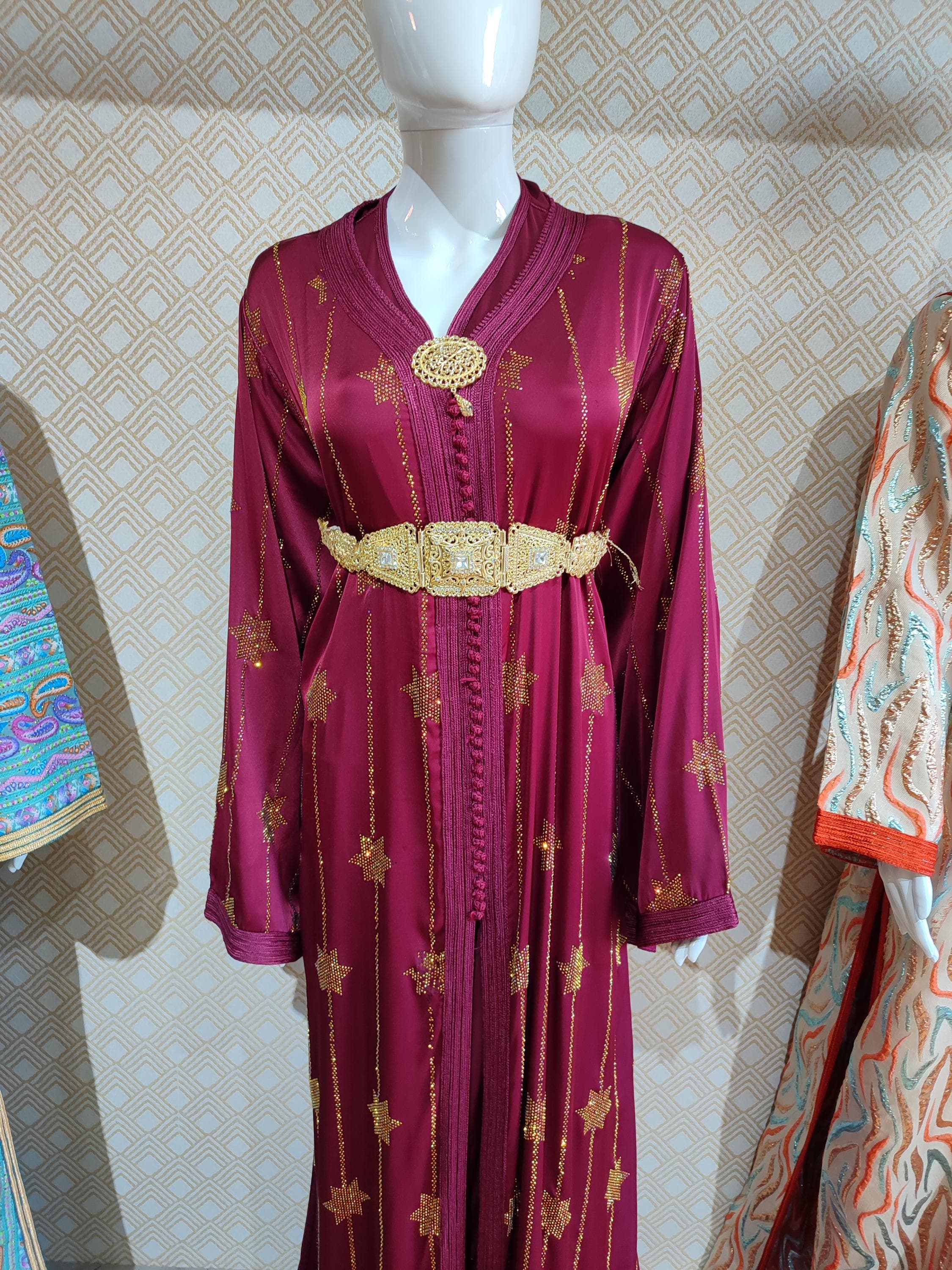 Reimagine the traditional bridal thobe with this contemporary nikah kaftan. This Arabic kuftan blends classic elegance with modern design, creating a sophisticated Muslim wedding dress. The clean lines and focused embellishment offer a refined and elegant kaftan option for the discerning bride. Perfect for a nikah ceremony or as a reception wedding dress, this piece provides both modesty and high fashion. It’s an ideal choice for those seeking a minimalist yet profoundly
