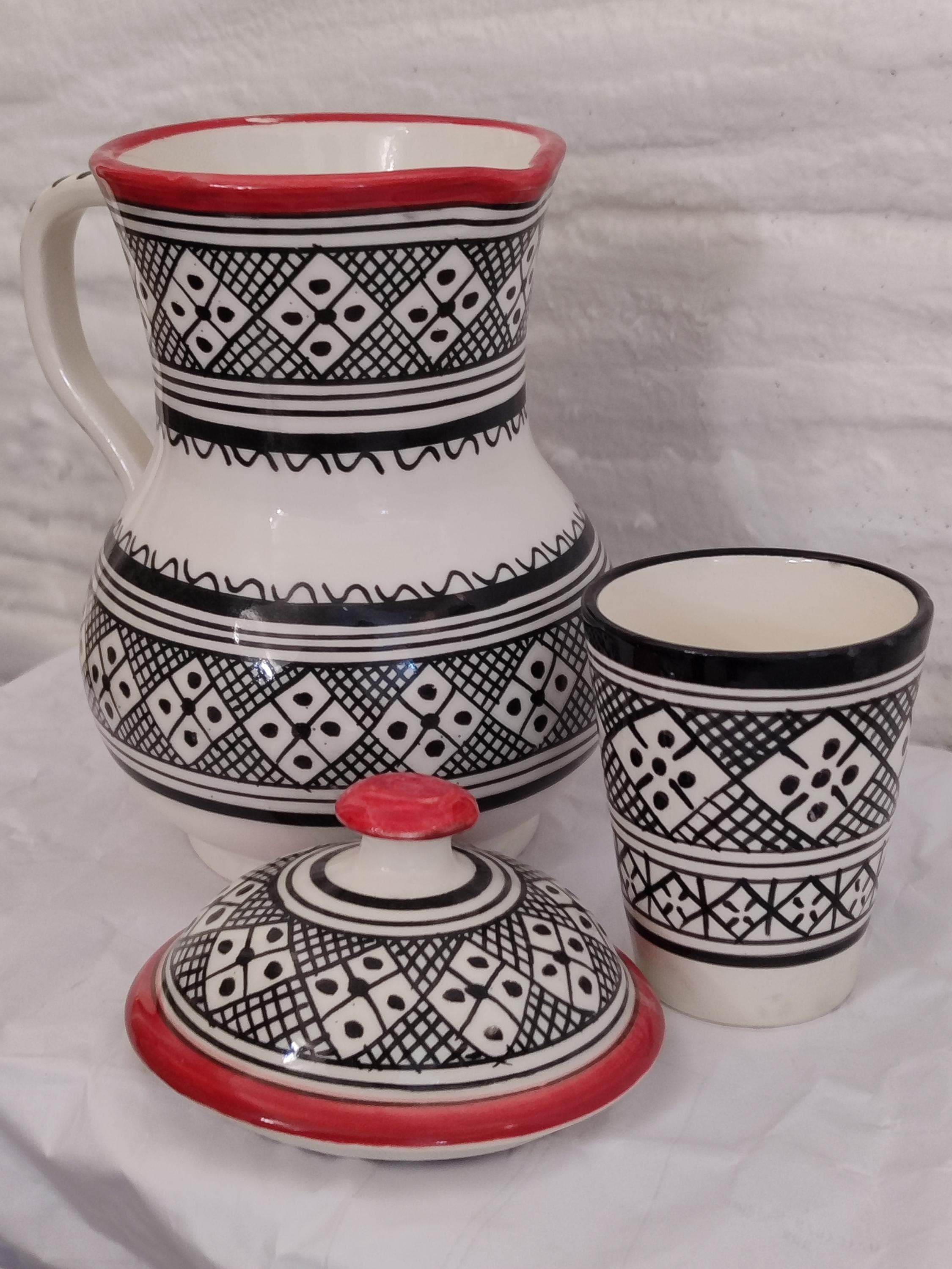 Elevate your space with this Handmade Moroccan Water Carafe Set, featuring a unique pottery carafe with lid and matching cup. This bedside carafe brings charm and history to your decor, rooted in Moorish art. A perfect glass carafe alternative for those who love elegant, handmade, and functional pieces.