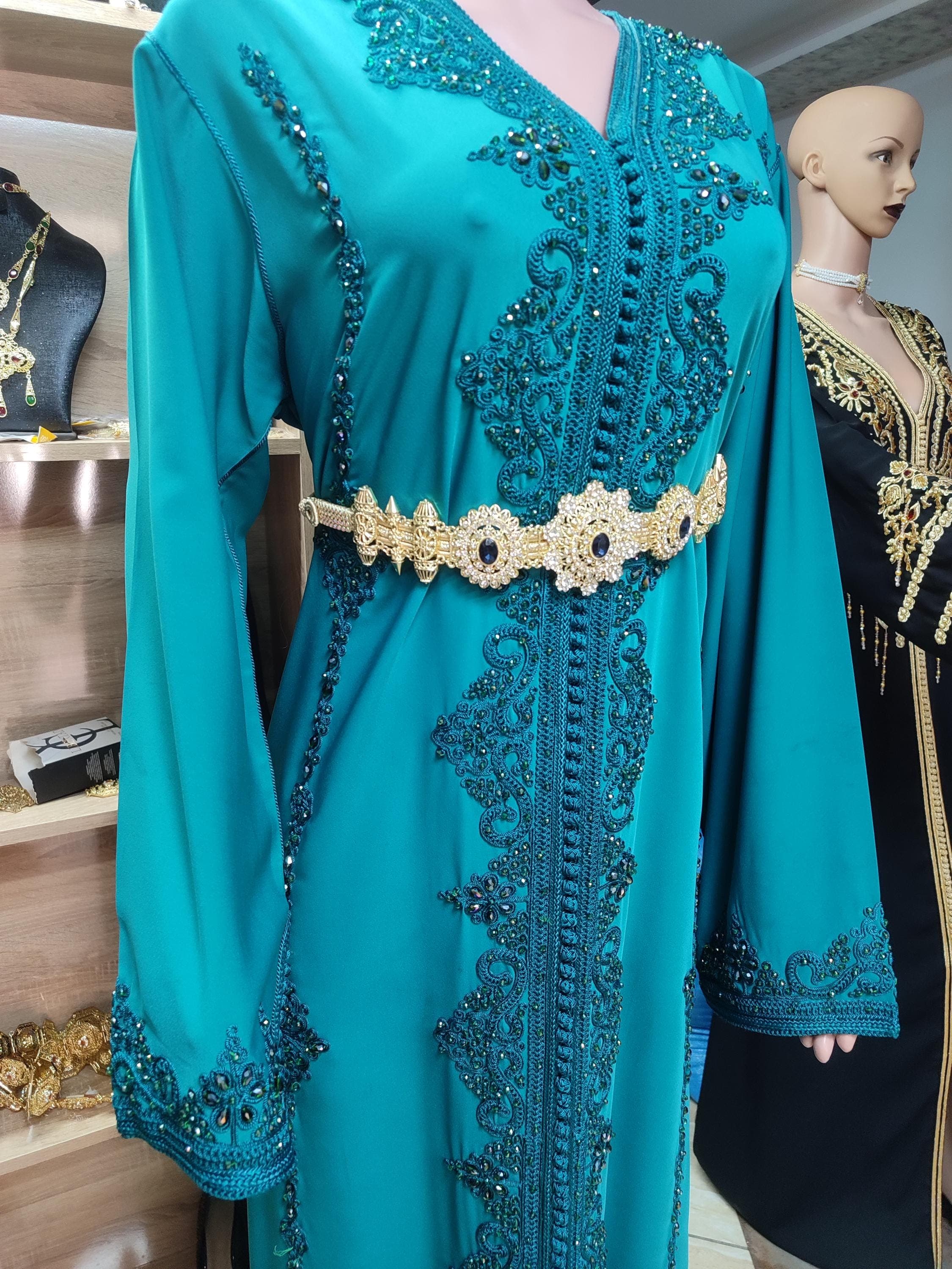 Our premium caftan marocain represents the pinnacle of Moroccan kaftan craftsmanship. Designed as an elegant robe de fete, this new caftan features hand-embroidered patterns using traditional techniques passed down through generations. The flowing Arabic kuftan silhouette flatters all body types while maintaining modest elegance. Perfect as a nikah dress or for other formal celebrations, this luxury kaftan comes in rich jewel tones with coordinating belt.