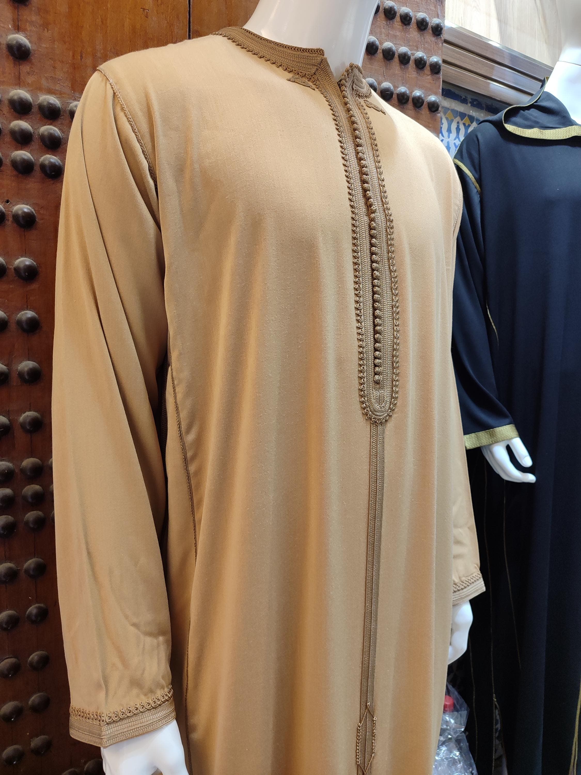 This djellaba wool piece represents the pinnacle of traditional craftsmanship, designed specifically for wedding outfit men. The sophisticated beige color is enhanced by detailed gold embroidery, creating a perfect Moroccan thobe for formal occasions. The high-quality wool fabric ensures comfort and elegance, making it ideal for special occasionwear. A genuine handmade piece that celebrates Moroccan heritage in style.