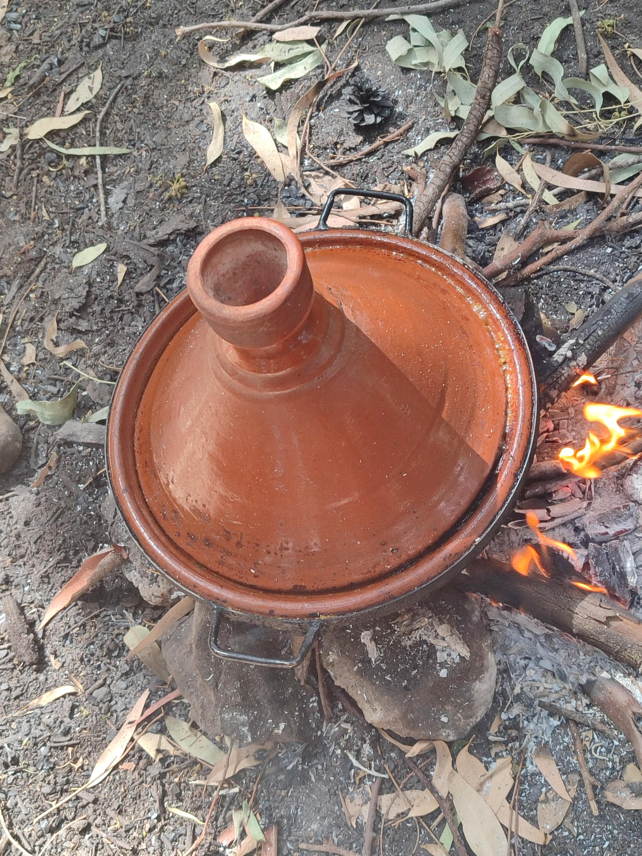 Experience the ultimate in traditional cooking with this large Moroccan clay pot, perfect for preparing a Tangia or big batches of curry. This substantial cooking vessel functions as a natural clay roaster oven, locking in moisture and flavor for fall-off-the-bone results. Its rustic, handmade design is inspired by the communal cooking pots of Marrakech. A must-have piece of Moroccan cookware for entertaining and family gatherings,
