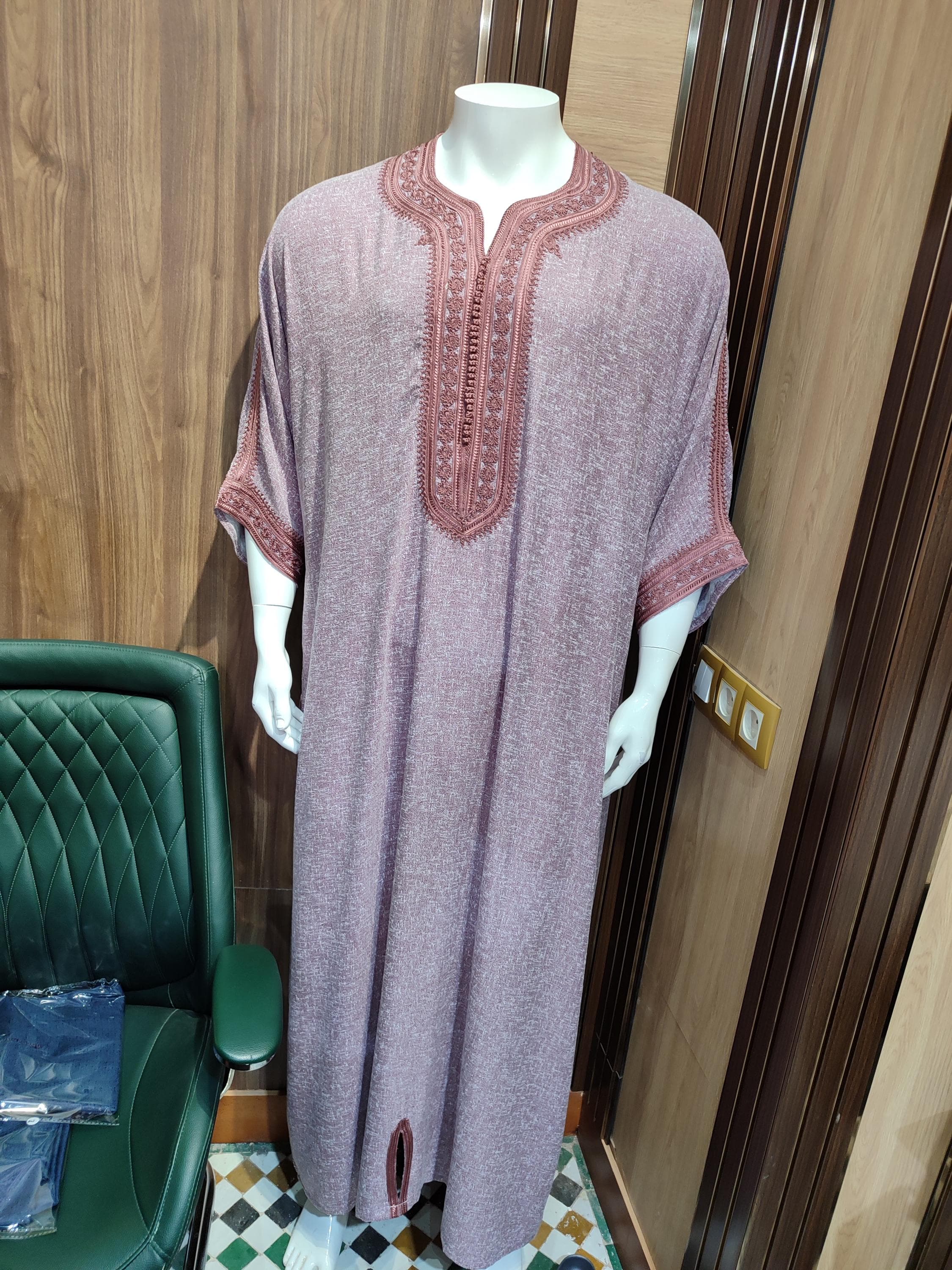 Experience ultimate comfort in this Moroccan menswear masterpiece. The kandoura cubbe is hand-sewn from premium cotton blend fabric, featuring the classic thobe silhouette with a modern twist. This Arabic dress showcases intricate geometric patterns along the chest and sleeves, reflecting authentic Islamic cloth traditions. The loose jubba cut ensures freedom of movement while maintaining an elegant drape. Ideal for warm climates, this breathable Muslim long kurta