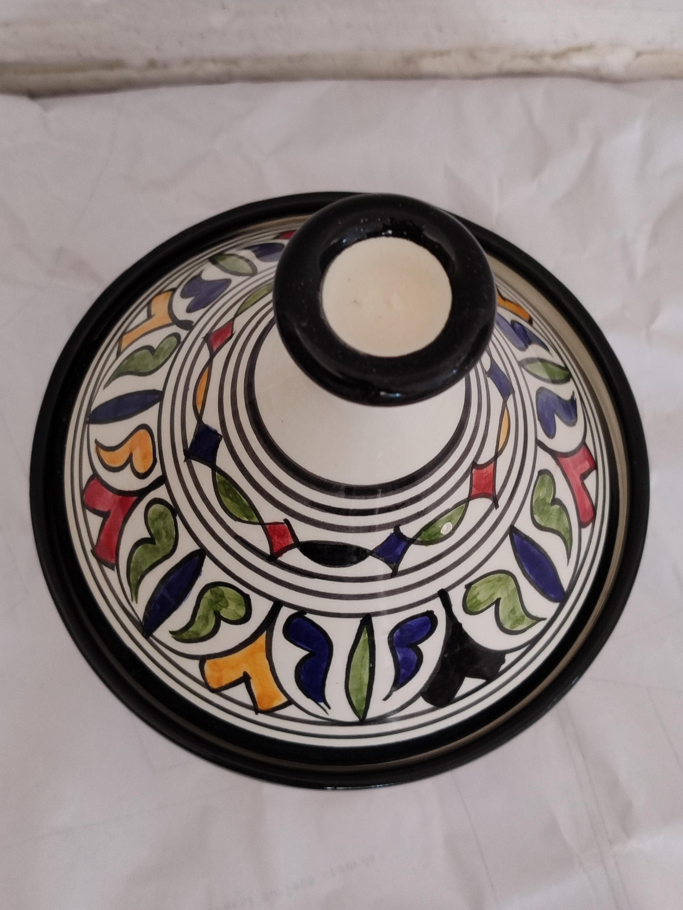 Authentic Handmade Clay Tagine for Traditional Moroccan Cuisine 
Experience the true flavor of Moroccan cuisine with this authentic handmade clay tagine. This traditional cookware piece is crafted from natural clay, designed for the slow-cooking methods that make Moroccan dishes so rich and flavorful. The unglazed interior perfectly retains moisture and enhances taste, while the classic conical lid traps steam. As a functional tagine for cooking and a beautiful ceramic pot,