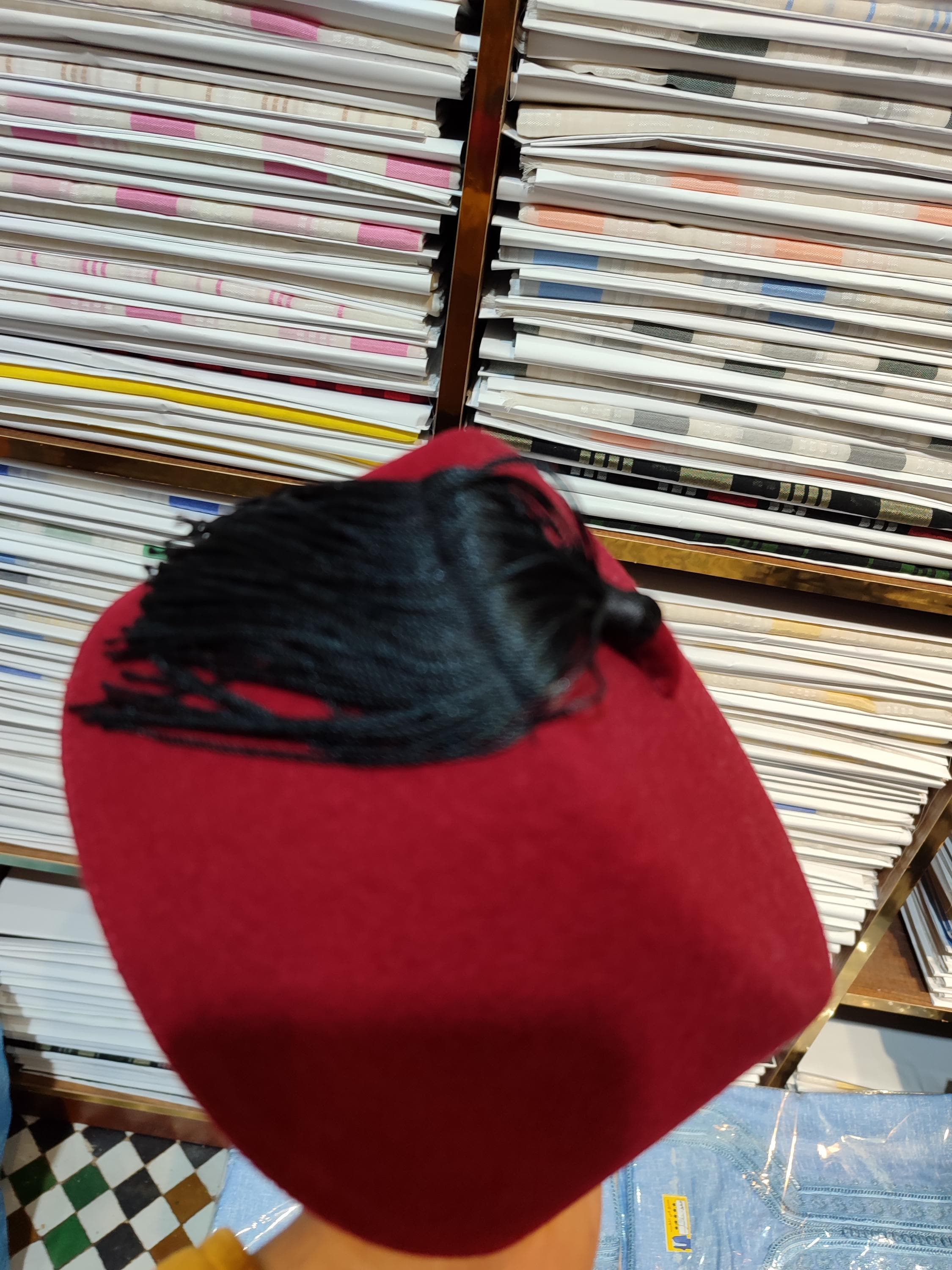 This handcrafted Fez Moroccan hat is a bold symbol of tradition and sophistication. Made from high-quality wool felt and covered in deep red velvet, it's perfect for ceremonies, cultural attire, or simply adding a refined touch to your everyday look. Whether you call it a tarboosh hat, ottoman fez, or mens felt hat, it offers authentic style rooted in North African and Islamic fashion. Ideal for pairing with djellaba marocaine or as part of Igbo cultural attire.