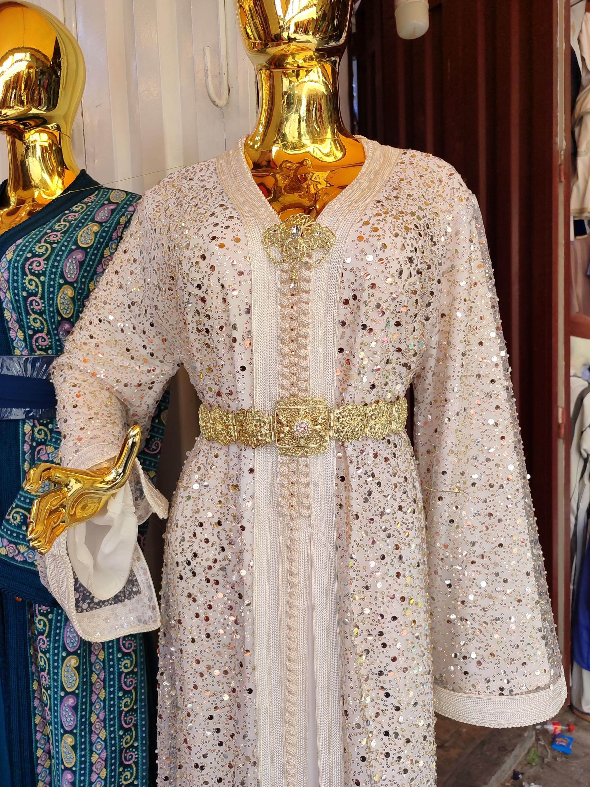 This breathtaking Palestinian thobe merges traditional Arabic Islamic dress with contemporary modest fashion. The pristine white fabric is adorned with authentic Palestinian dress embroidery patterns, creating a luxury kaftan suitable for bridal occasions or formal events. The maxi gown silhouette flows gracefully while maintaining perfect modesty, making it ideal as a Muslim nikah dress or henna dress.