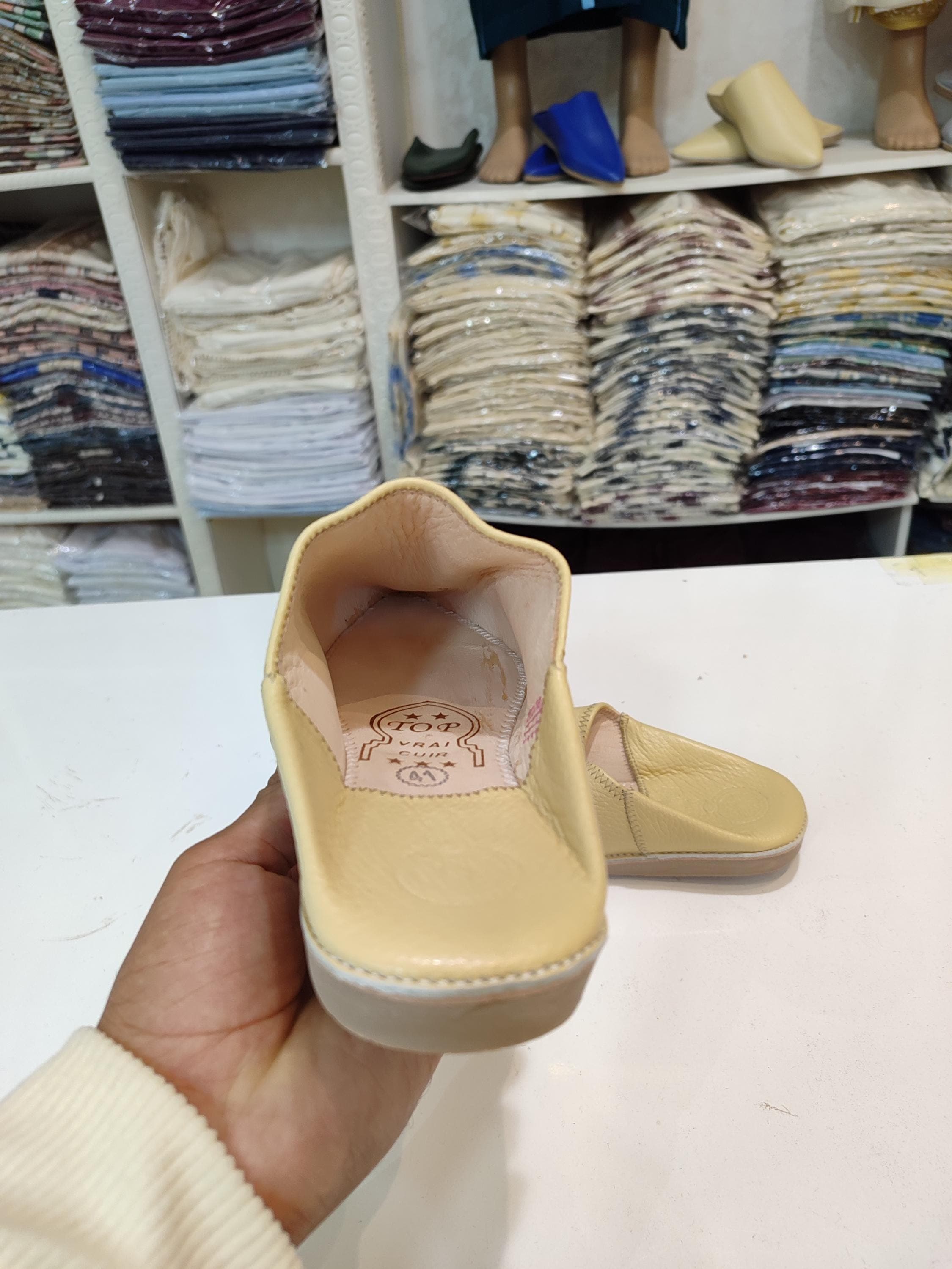 Embrace the rich culture of Morocco with our authentic Fez shoes, meticulously handmade from premium organic leather. These Moroccan babouche slippers feature a classic pointed toe and a comfortable mule design, perfect for lounging or special events like Moroccan wedding celebrations. The beige color adds a touch of sophistication, while the handmade craftsmanship ensures durability and comfort. Whether worn with a Moroccan thobe or casual wear,