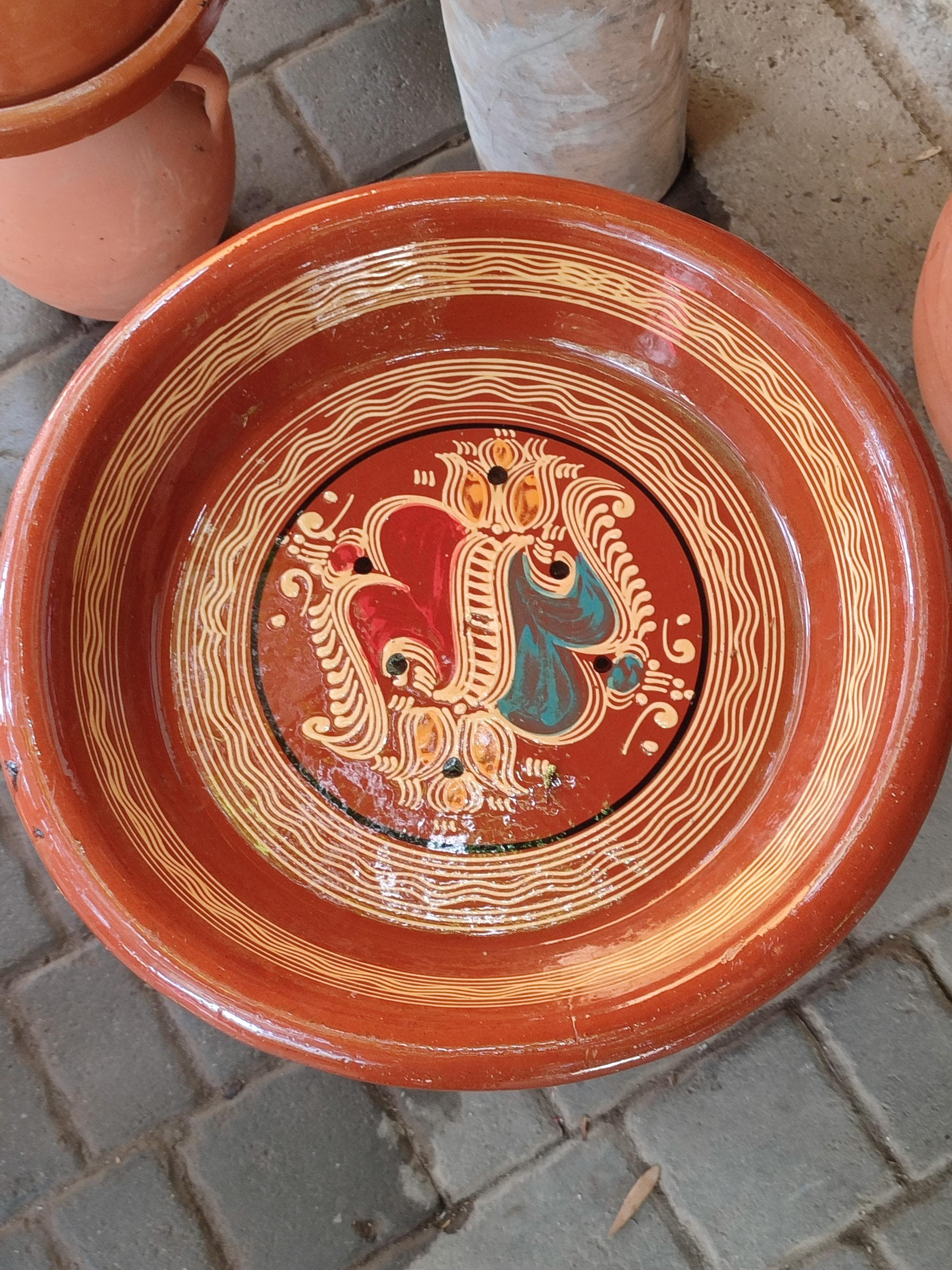 This stunning Moroccan Kesriya terracotta dish is the ultimate couscous plate, designed to beautifully serve a feast for 8 people. Handcrafted with traditional techniques, this large Moroccan serving pot is the centerpiece of authentic Moroccan tableware. Its wide, shallow design is perfect for presenting couscous, salads, or grilled meats in the traditional way. The intricate patterns and natural terracotta finish make it a piece of Moroccan wall art when not in use.