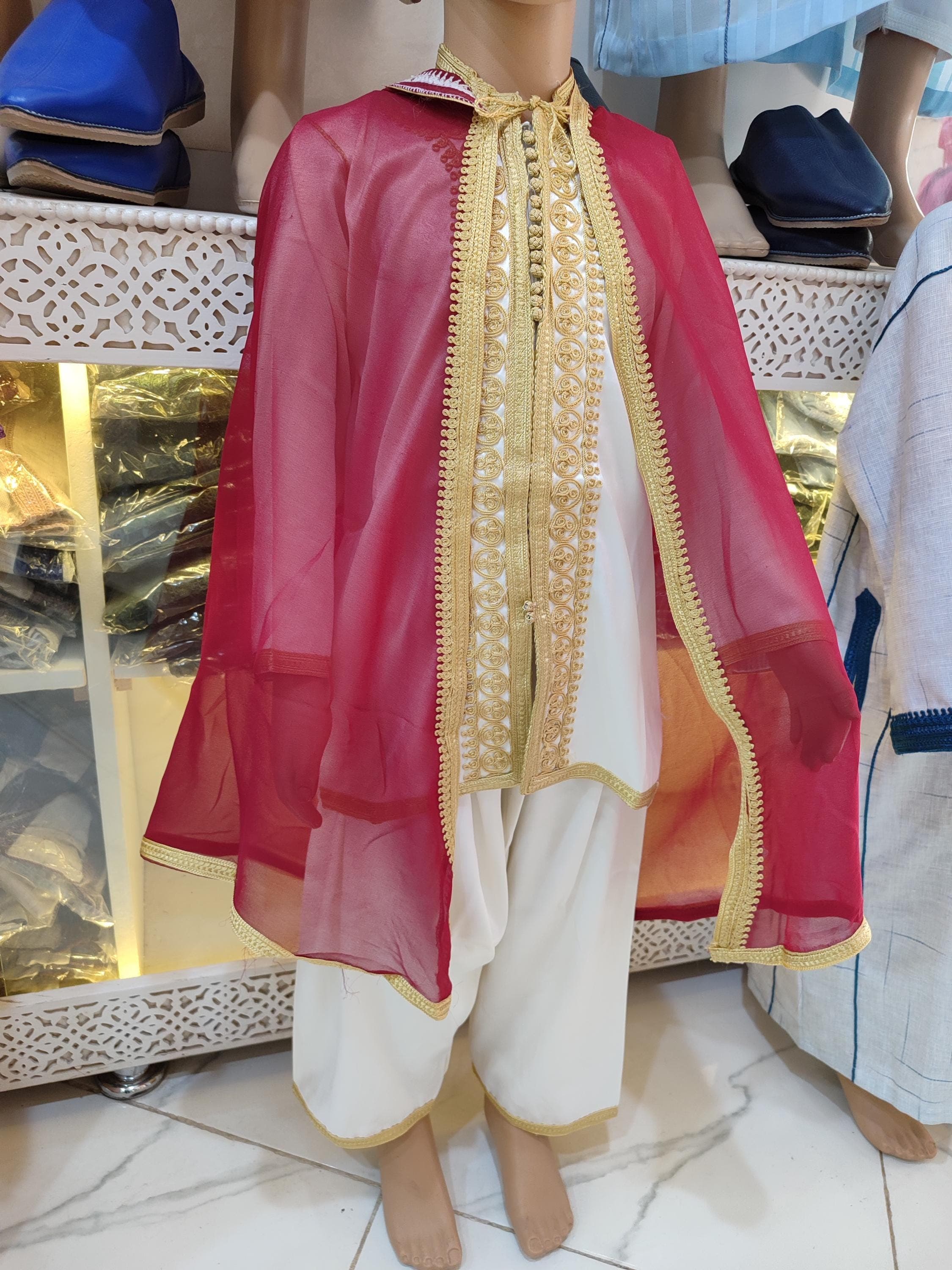 Our boys jabador set offers authentic Moroccan style for young gentlemen. This child jabador features intricate handmade embroidery on premium chiffon fabric, creating a luxurious traditional outfit. Perfect for boys Eid dress occasions, aqiqah celebrations, or formal events. The 3-piece design includes a kaftan-style top, matching pants, and decorative vest, all tailored for comfort and movement.