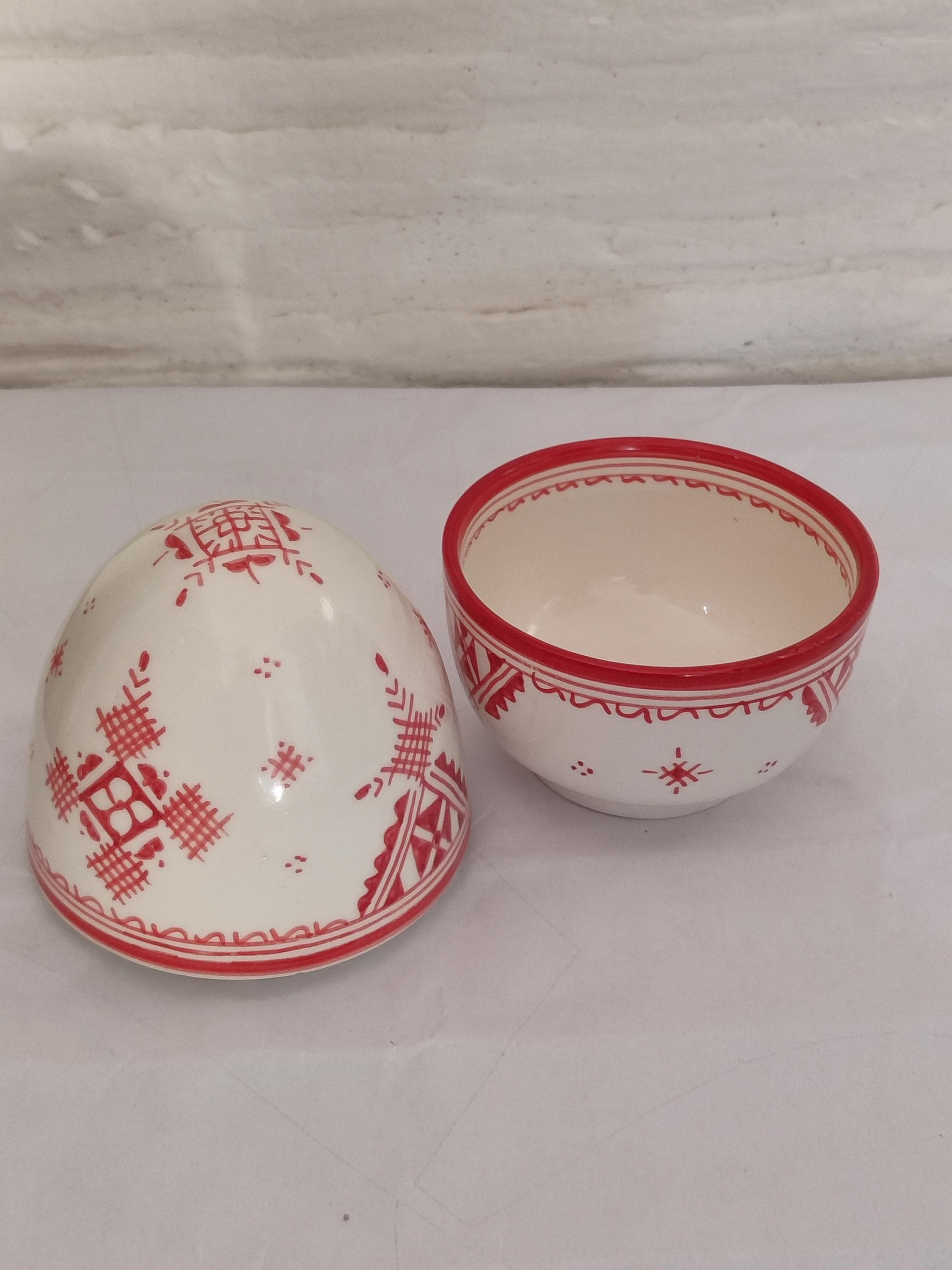 This handmade clay tagine is a beautiful representation of Moroccan ceramic art. While crafted in the authentic shape of traditional cookware, this piece is designed as a stunning decorative object. Its intricate details and classic form make it an essential element of Moroccan decor. Use it as a unique centerpiece bowl, a planter, or simply as a stand-alone sculpture that celebrates cultural art. This pottery Moroccan piece is a must-have for adding an authentic,