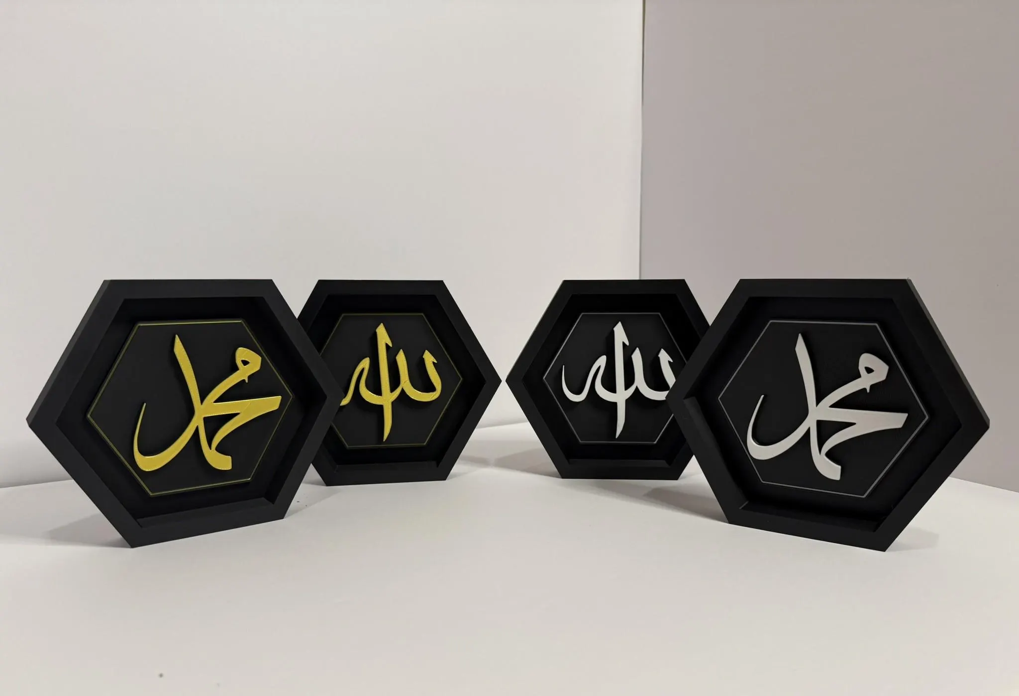 Black hexagon sets with white and gold Islamic Calligraphy