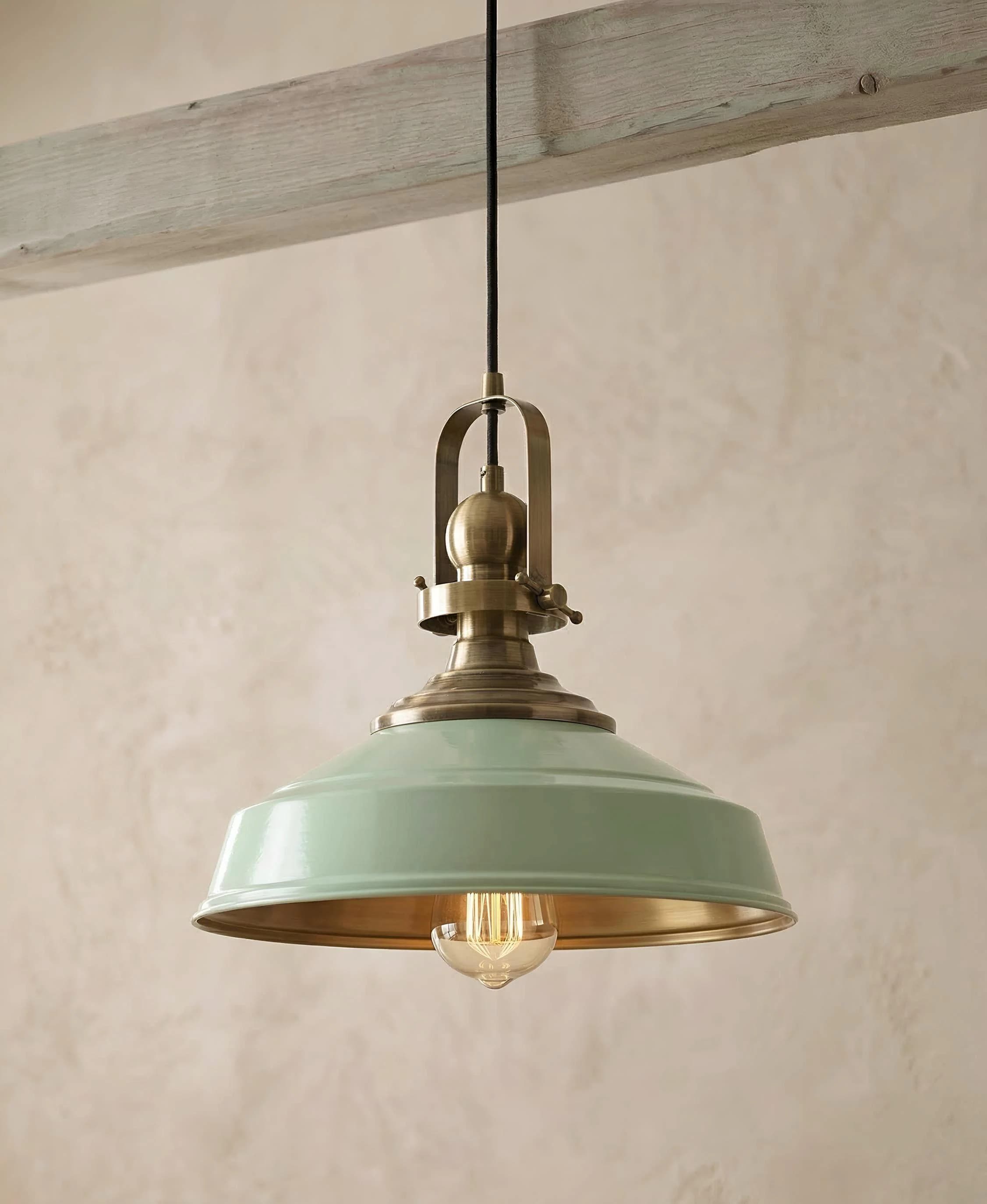Mint green vintage industrial pendant light with antique brass fixture hanging from a rustic wooden beam. Retro-style ceiling lamp with glossy enamel shade, 41cm wide and 28cm tall. E27 socket, compatible with LED and energy-saving bulbs up to 60W. Perfect farmhouse or loft pendant light for kitchen islands, dining rooms, and cafe interiors.
