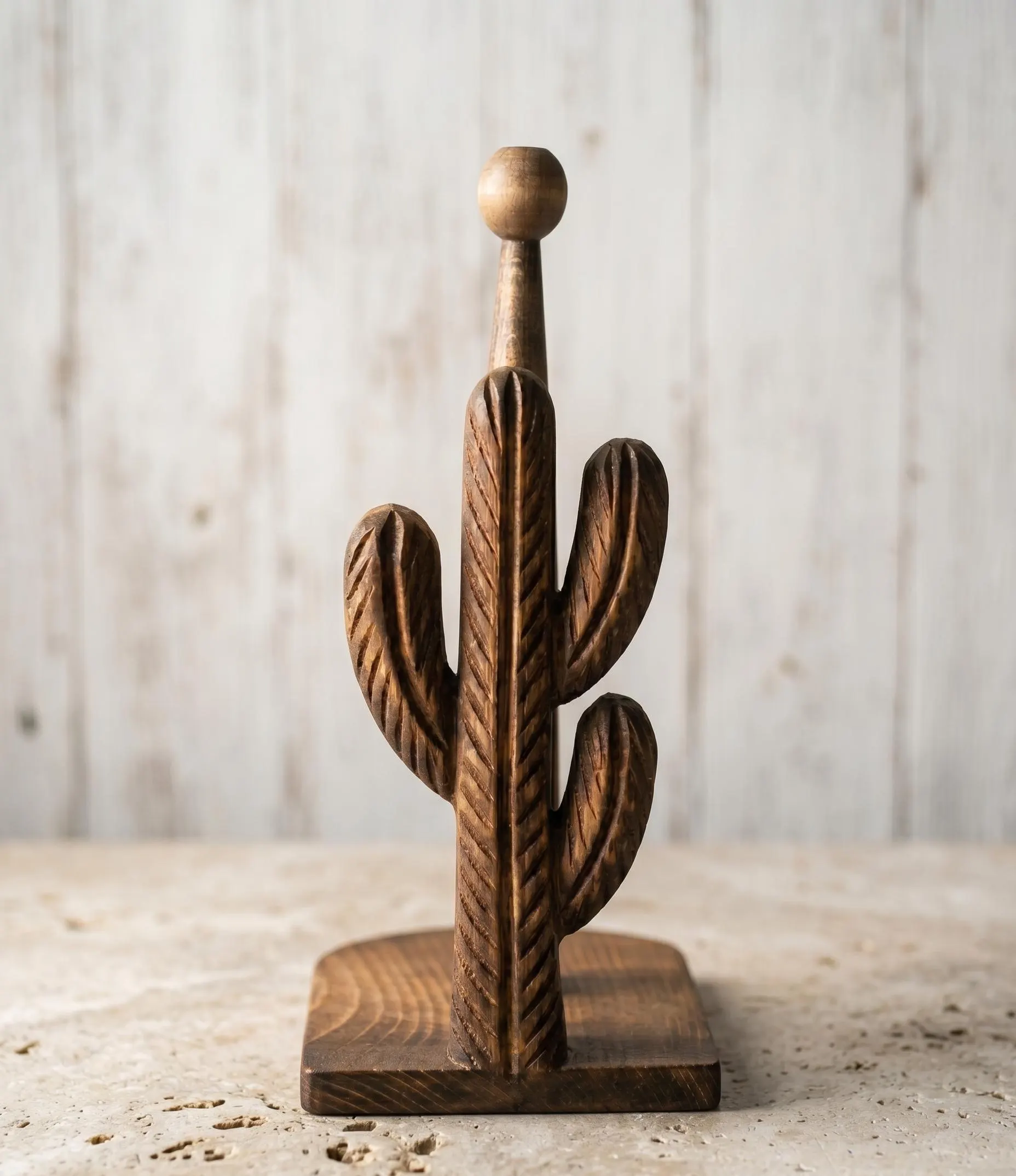 Dark brown carved wooden cactus kitchen paper towel stand with visible natural wood grain and rustic western decor aesthetic.